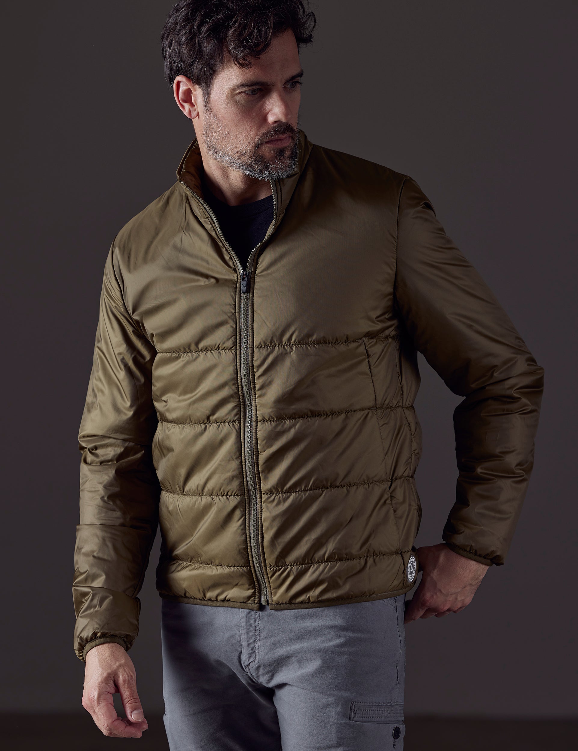 Front body view of man wearing Eco Insulated Jacket in Command Green from AETHER Apparel.