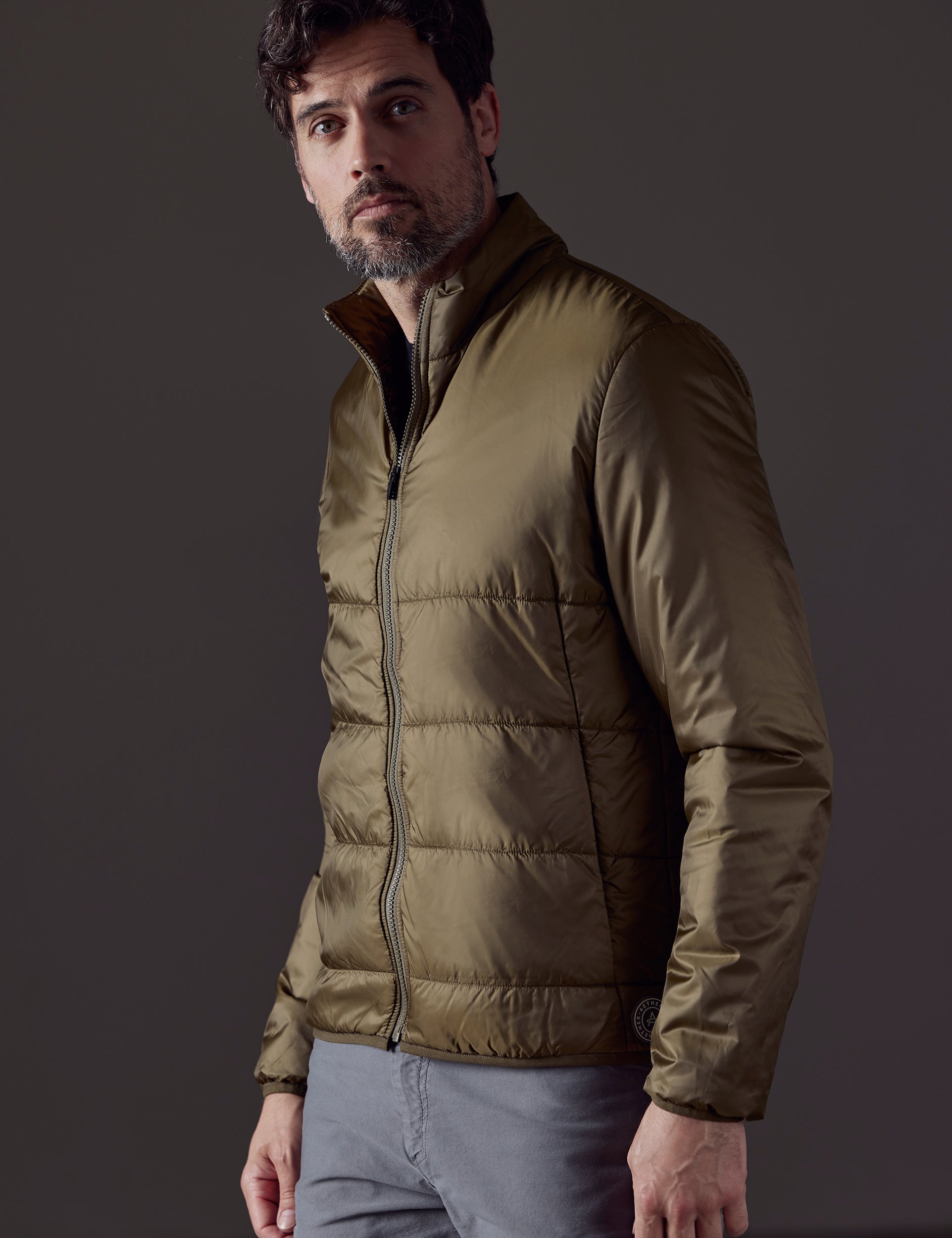 Front 3/4 body view of man wearing Eco Insulated Jacket in Command Green from AETHER Apparel.