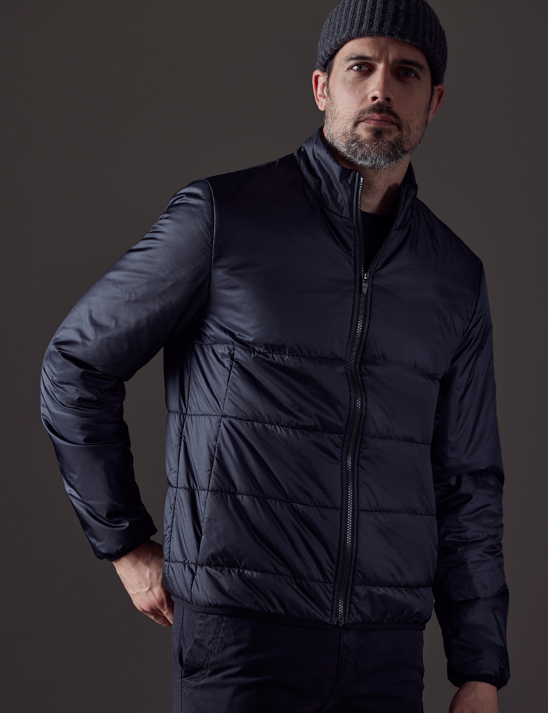 Front 3/4 body view of man wearing Eco Insulated Jacket in Onyx Black from AETHER Apparel.