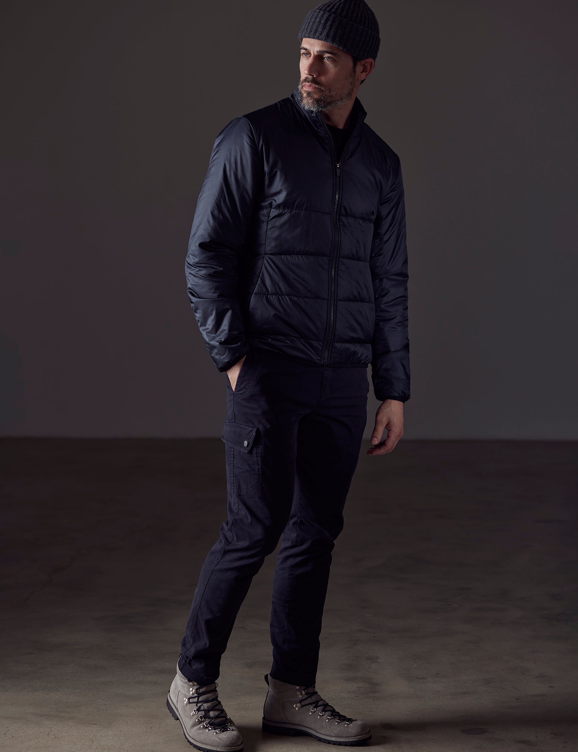 Front 3/4 full-body view of man wearing Eco Insulated Jacket in Onyx Black from AETHER Apparel.
