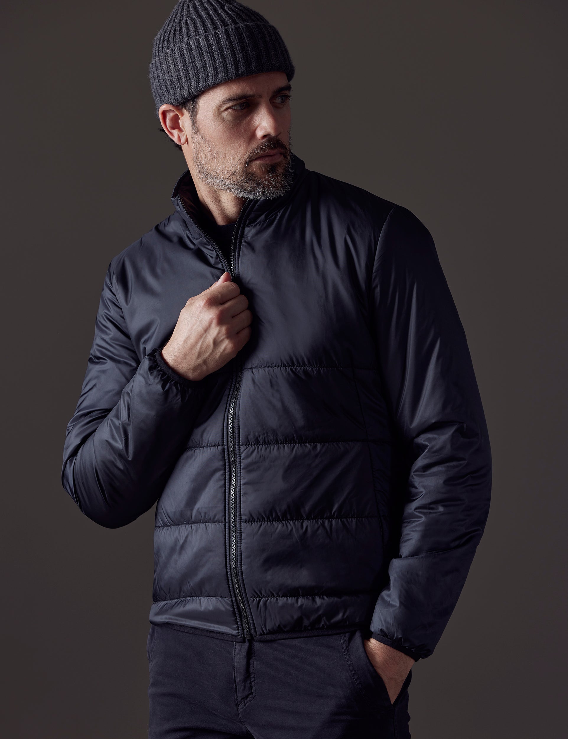 Front body view of man wearing Eco Insulated Jacket in Onyx Black from AETHER Apparel.