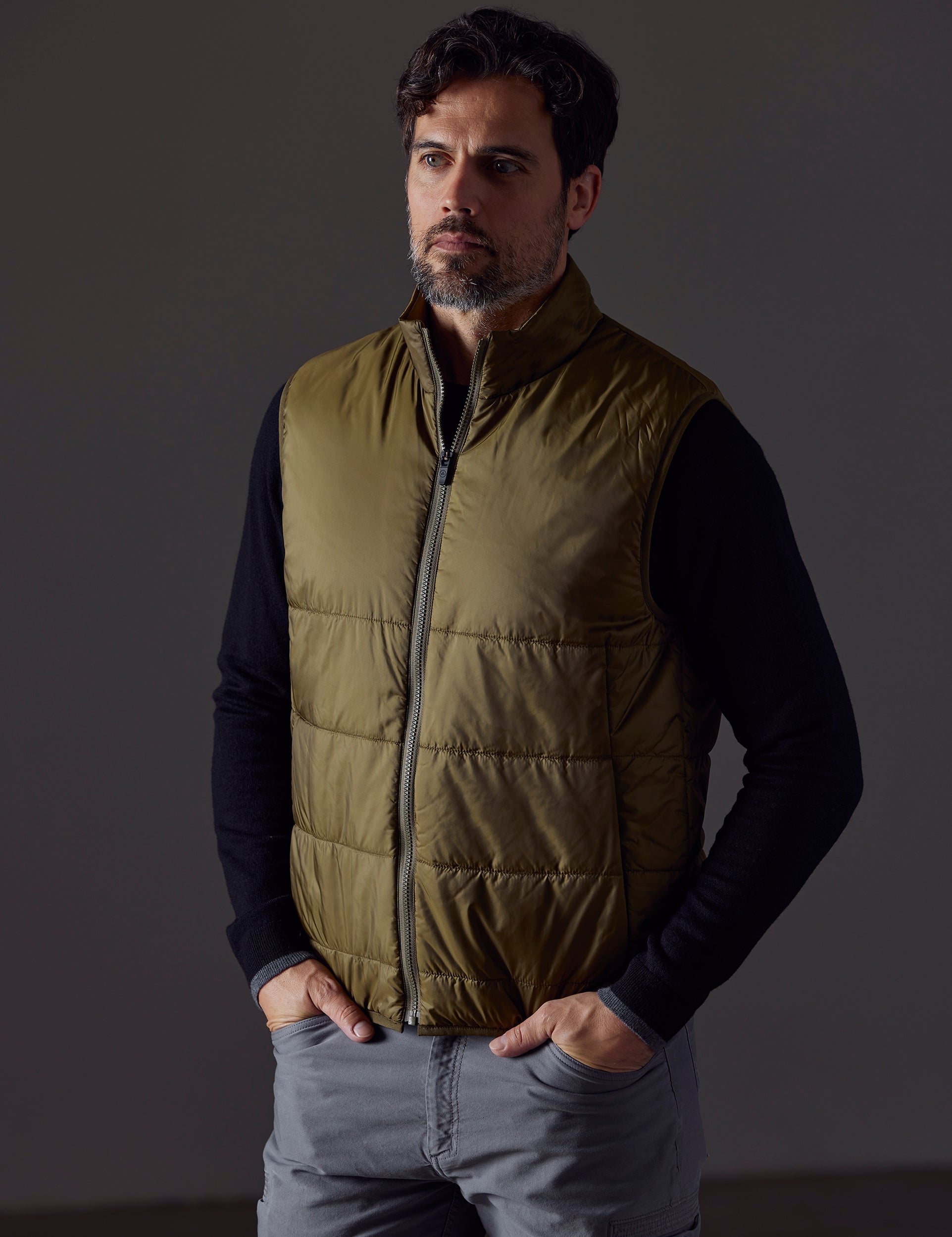 Front 3/4 body view of man wearing Eco Insulated Vest in Command Green from AETHER Apparel.