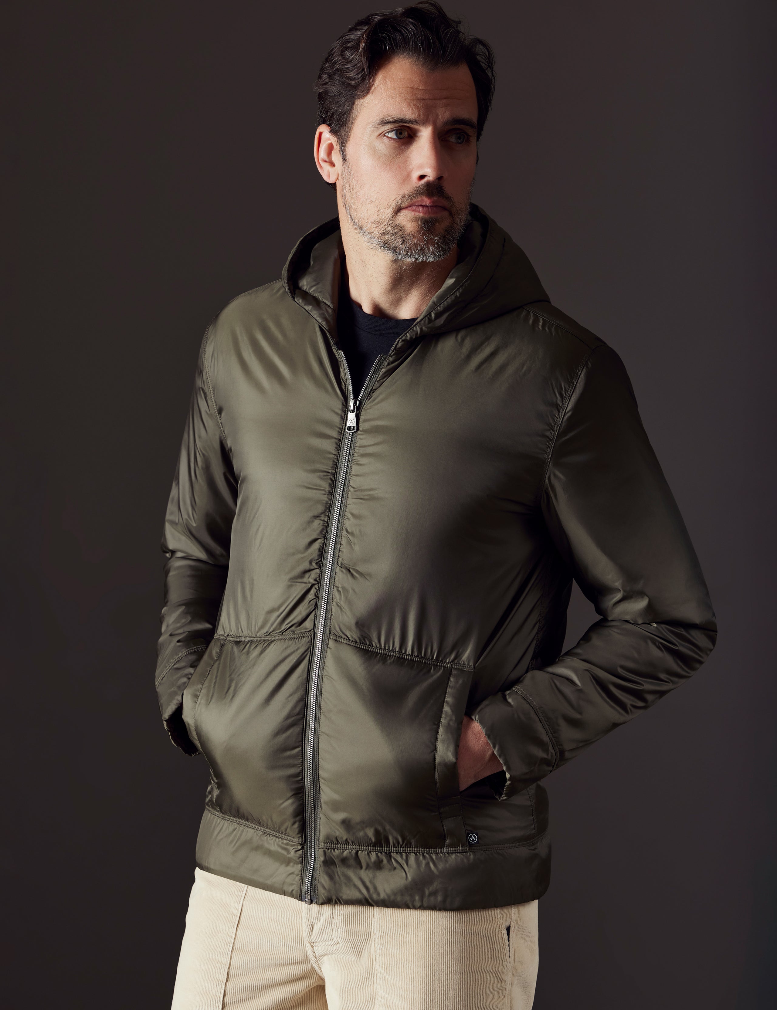 Front 3/4 body view of man wearing Eco Space Hoodie in Hunter Green from AETHER Apparel.