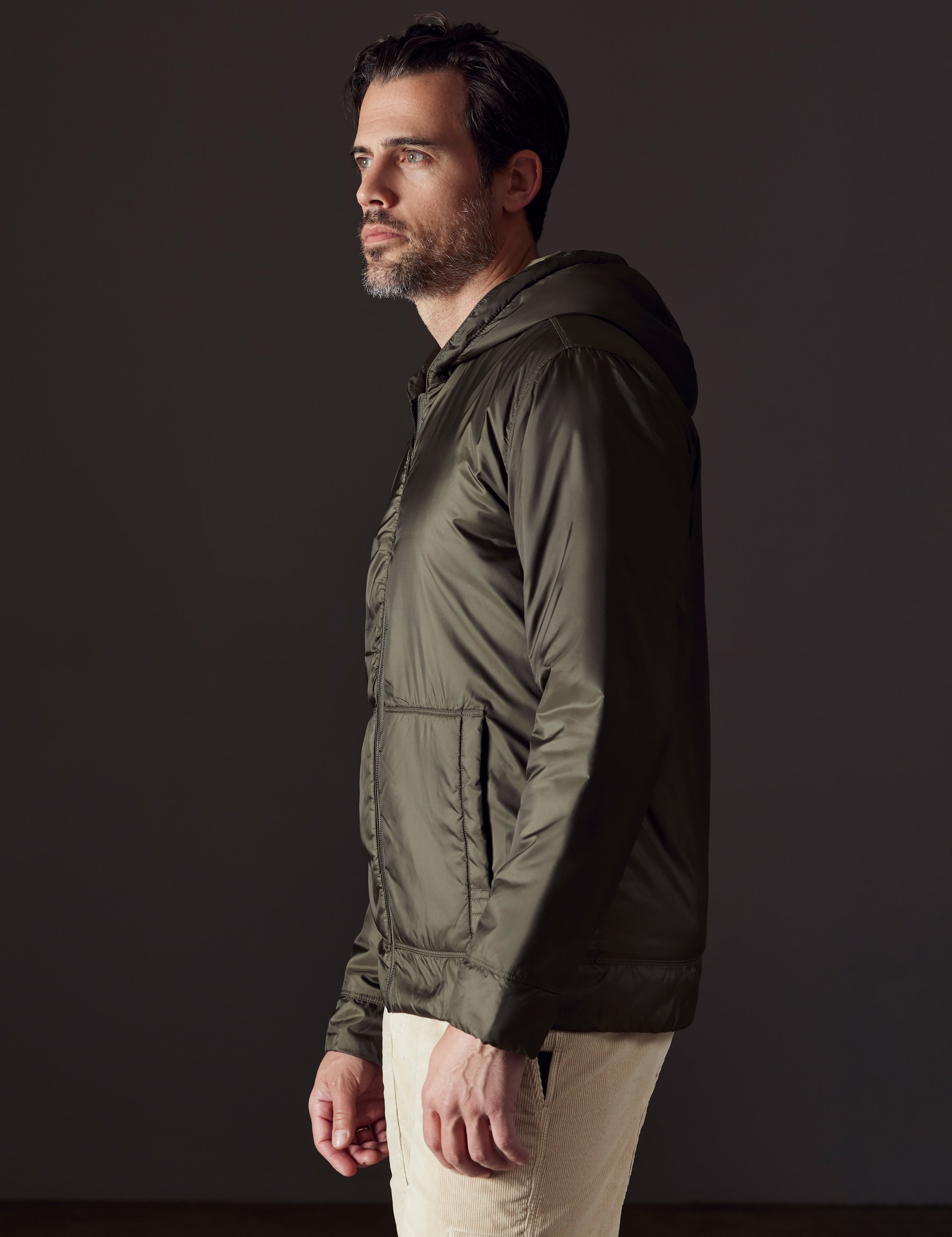 Side profile body view of man wearing Eco Space Hoodie in Hunter Green from AETHER Apparel.