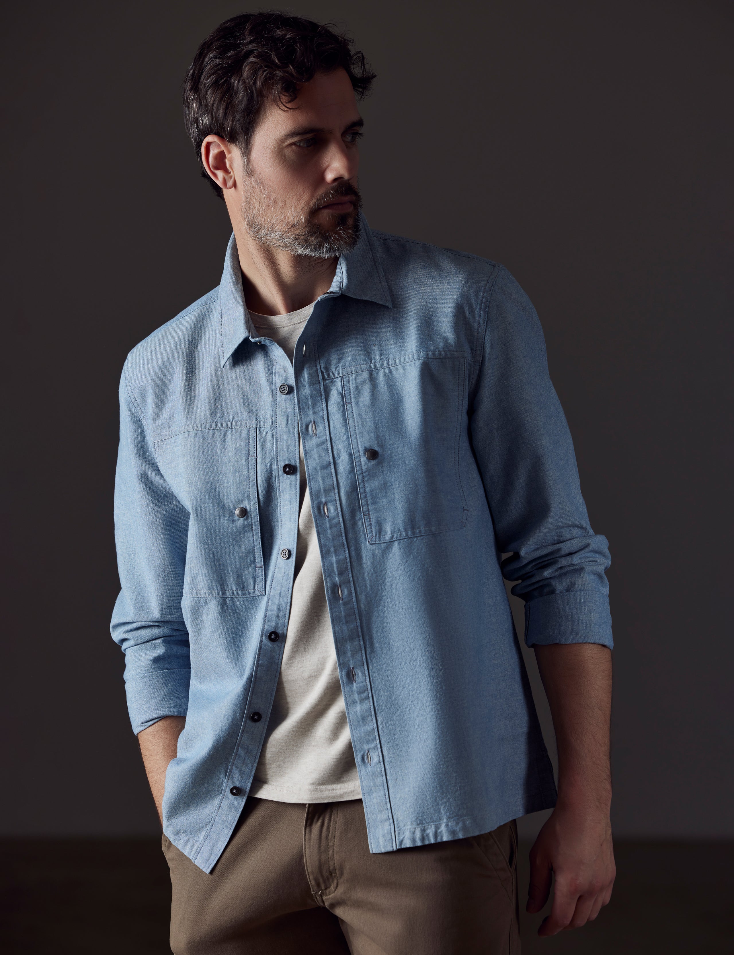 Front 3/4 body view of man wearing Emerson Button Down in Light Blue from AETHER Apparel.