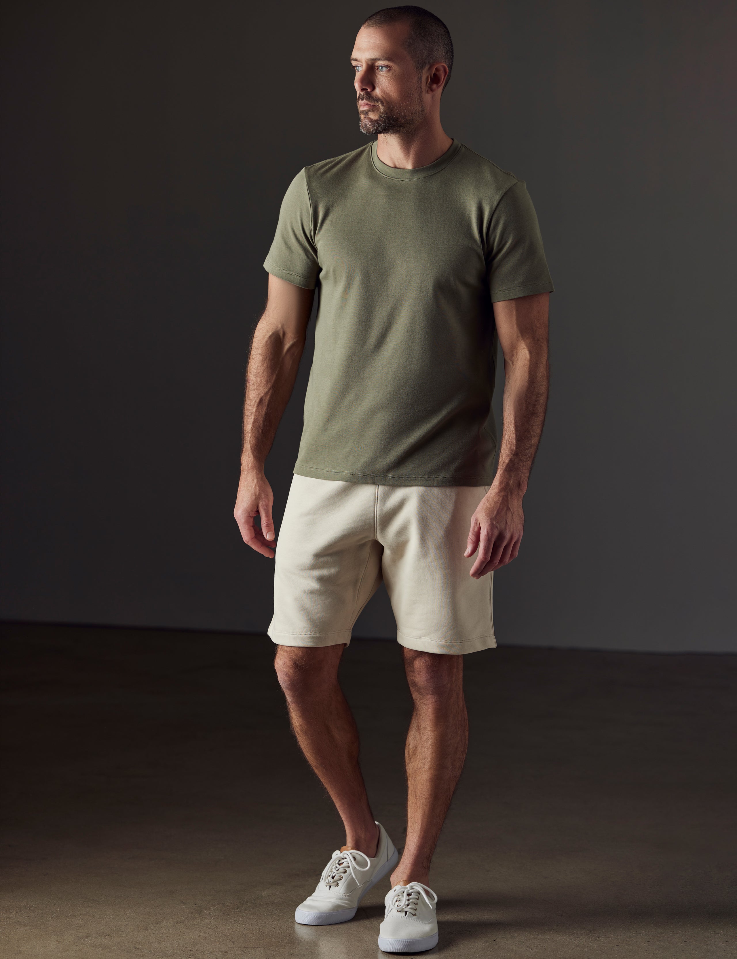 Front full-body view of man wearing Emery Pima Crew Tee in Fern Green from AETHER Apparel.