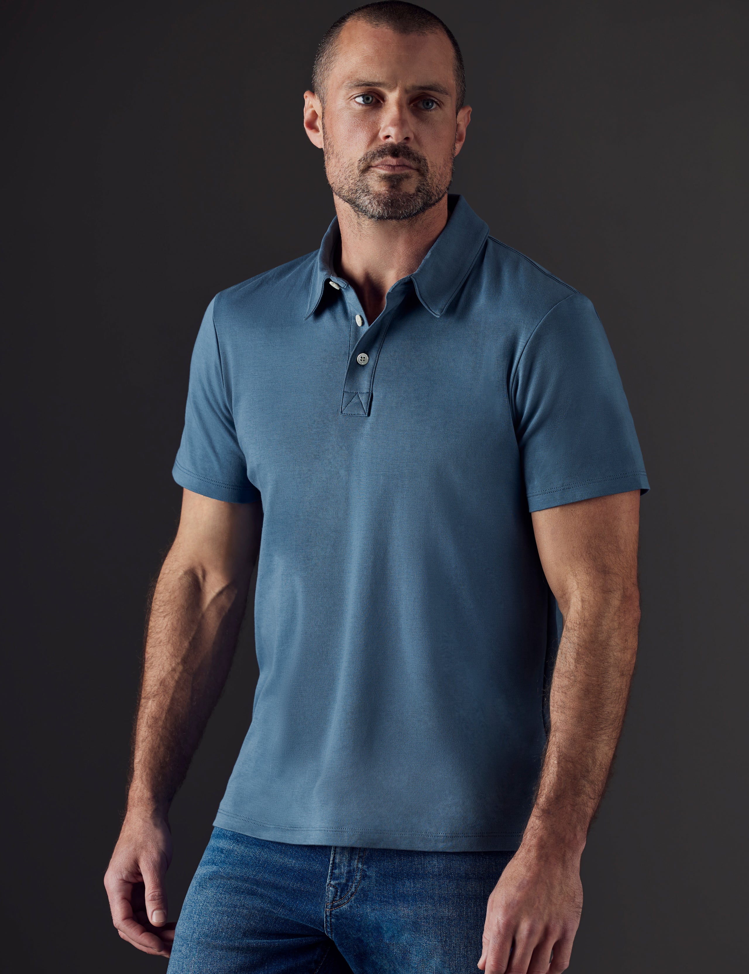 Front body view of man wearing Emery Pima Polo in Coastal Blue from AETHER Apparel.