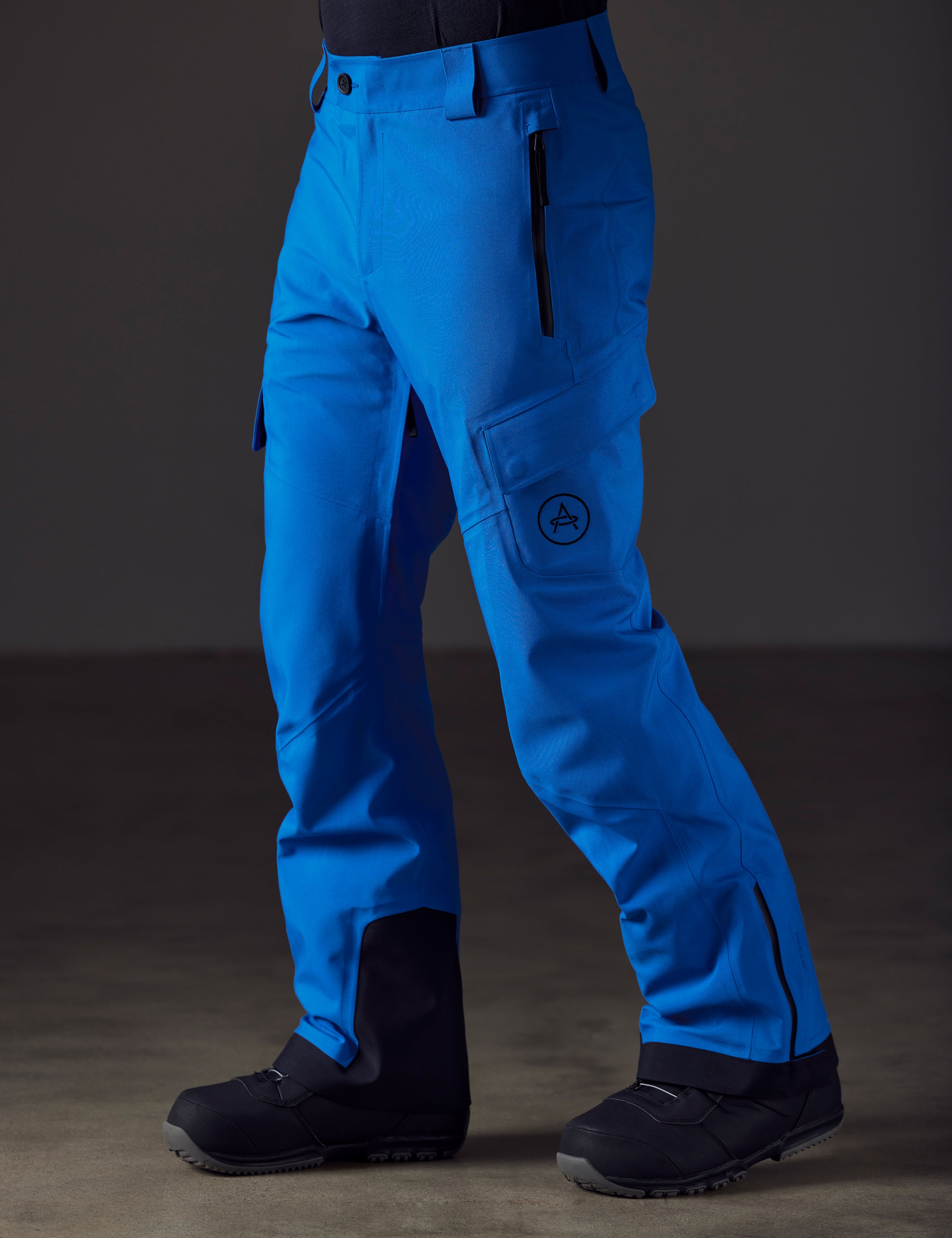 Front angled lower body view of man wearing Explorer Snow Pant in Summit Blue from AETHER Apparel.