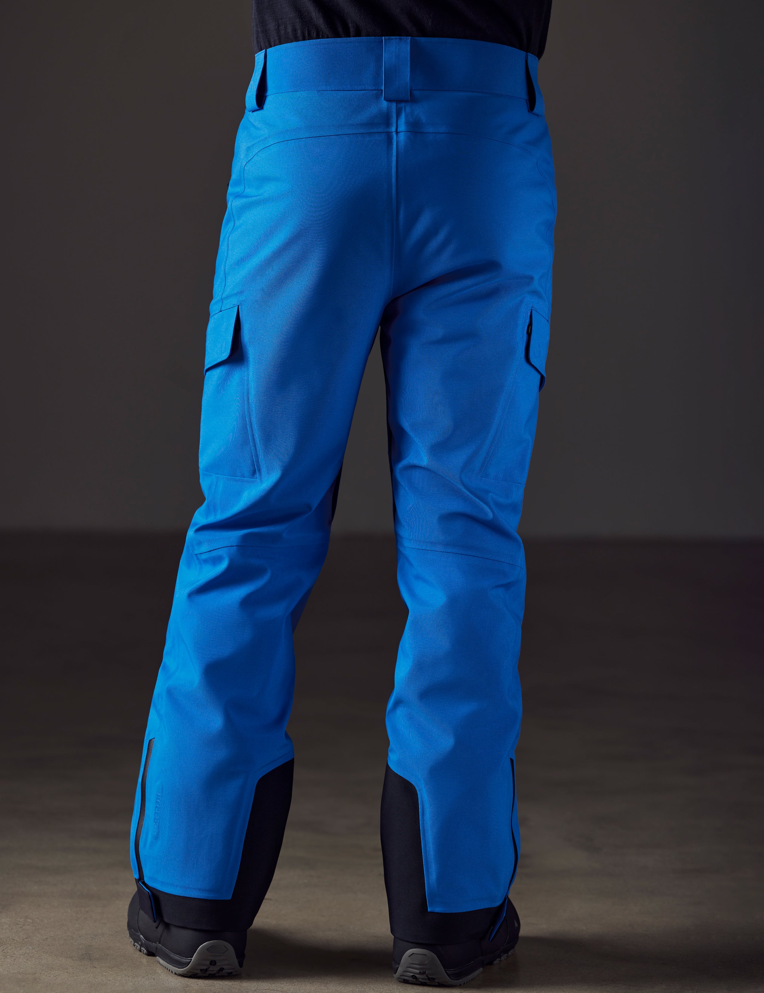 Rear lower body view of man wearing Explorer Snow Pant in Summit Blue from AETHER Apparel.