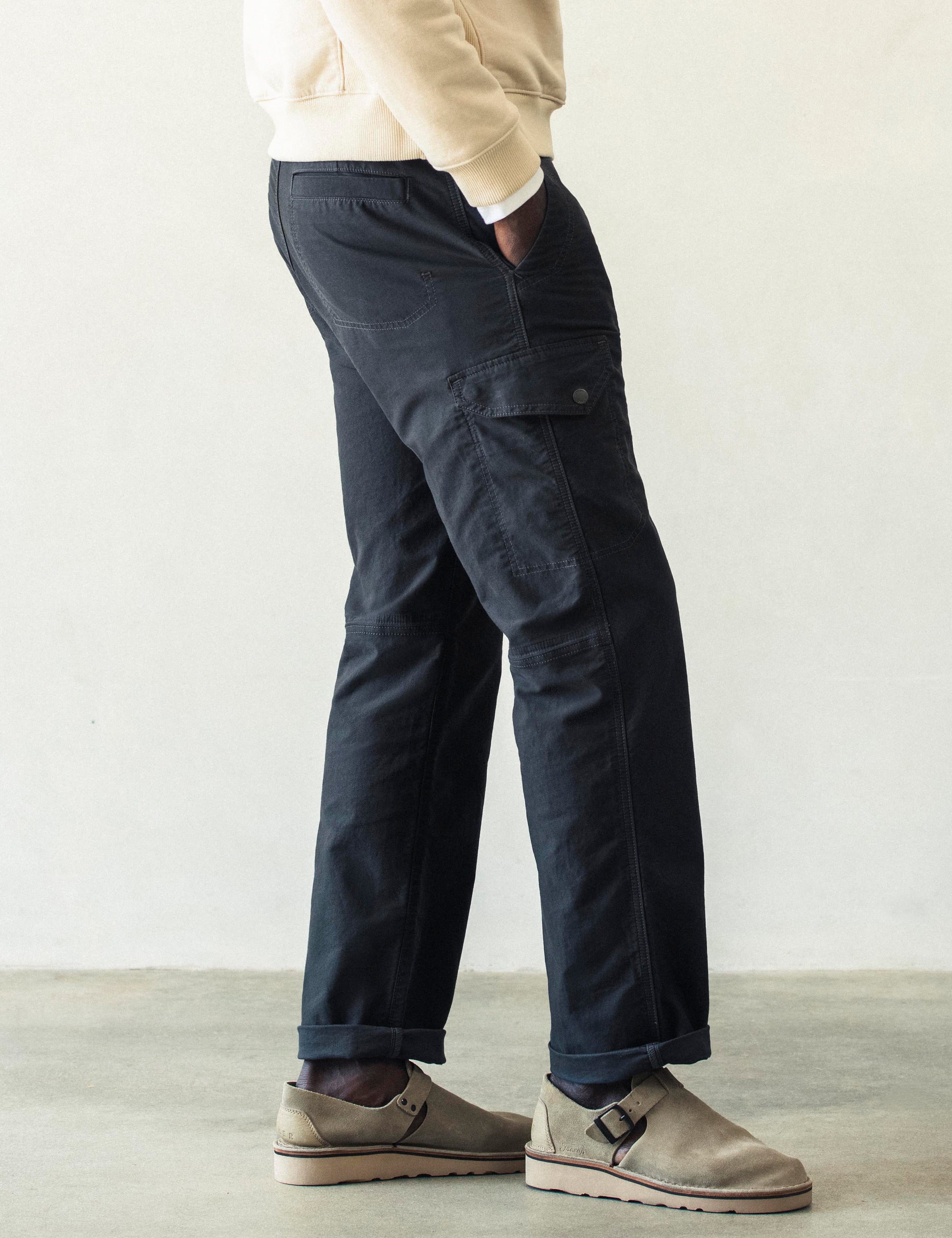 Right lower body view of man wearing Fairfax Pant 2.0 in Graphite from AETHER Apparel.