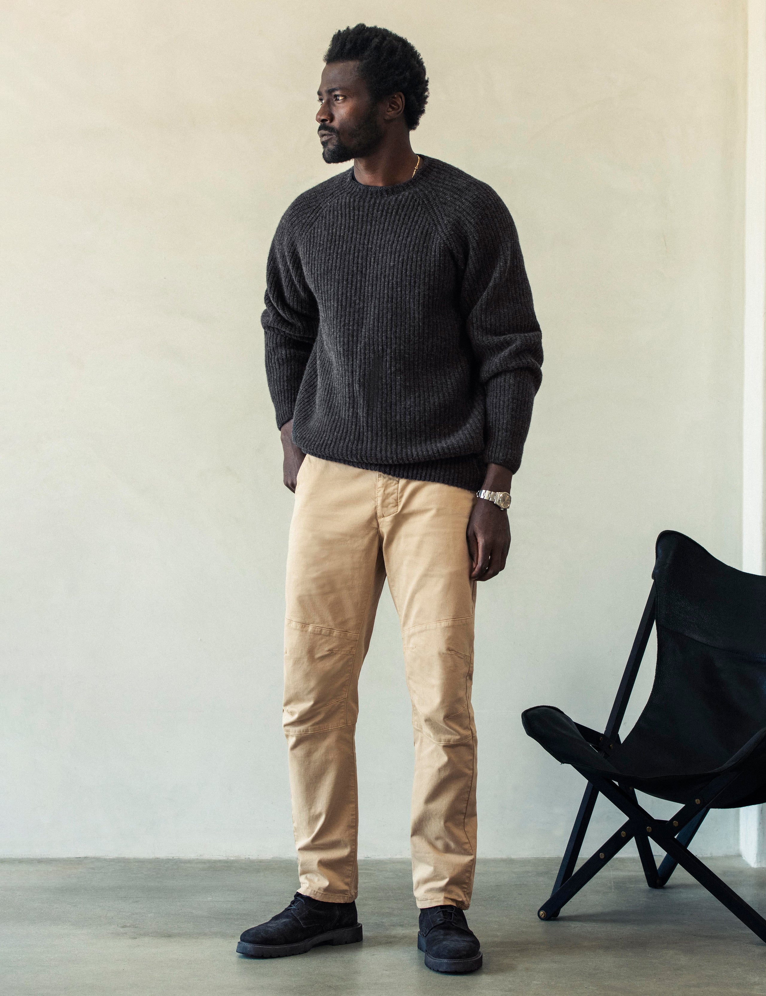 Front angled full-body view of man wearing Gabriel Articulated Chino Stretch pant in Desert Tan from AETHER Apparel.