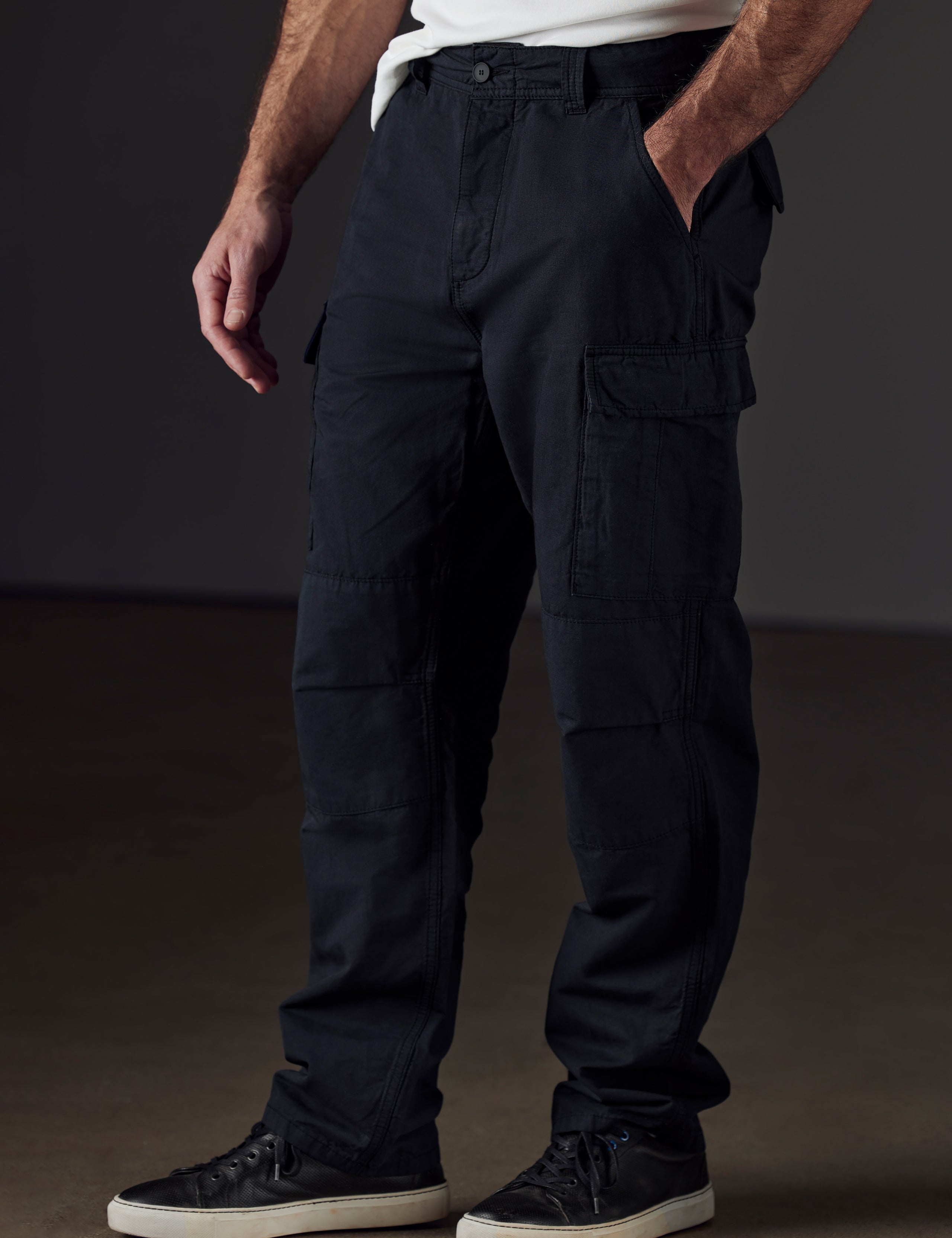 Front 3/4 lower body view of man wearing Glade Fatigue Pant in Onyx Black from AETHER Apparel.