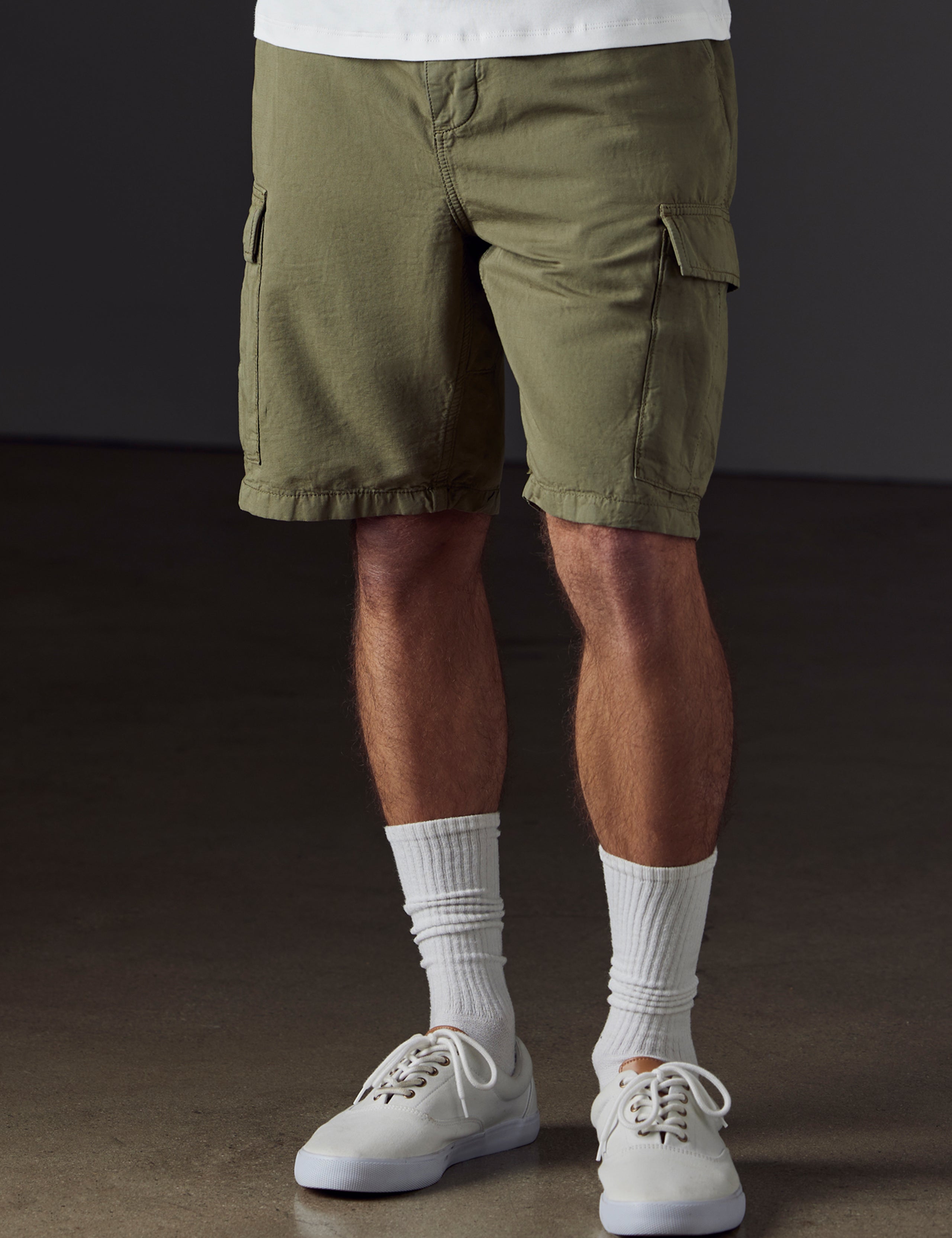 Front lower body view of man wearing Glade Fatigue Short in Fern Green from AETHER Apparel.