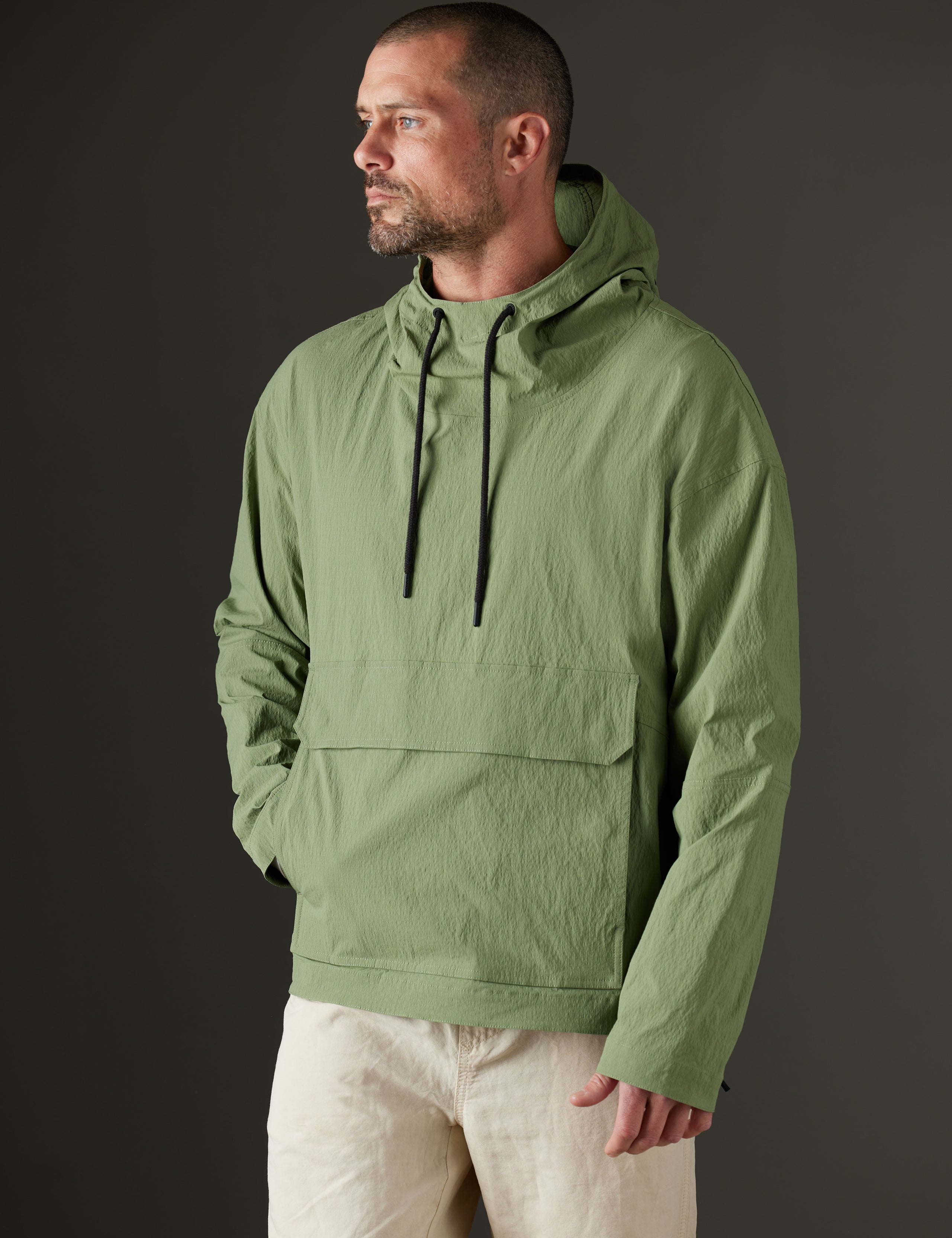 Front body view of man wearing Harrier Anorak in Mineral Green from AETHER Apparel.