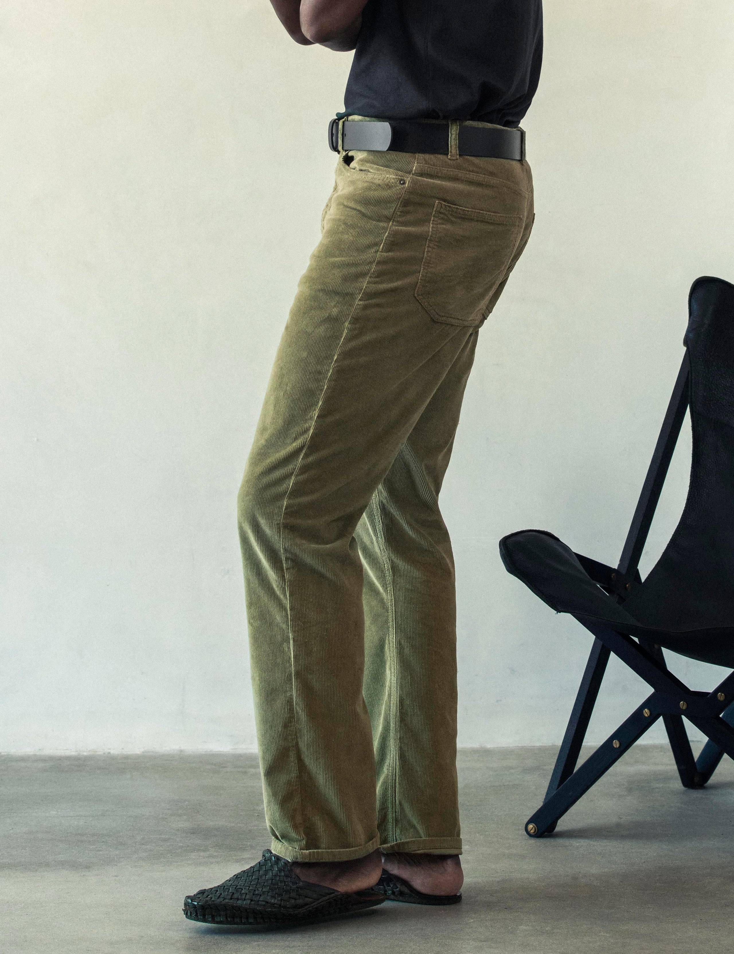 Side profile lower body view of man wearing Hayden Corduroy Pant in Fern Green from AETHER Apparel.