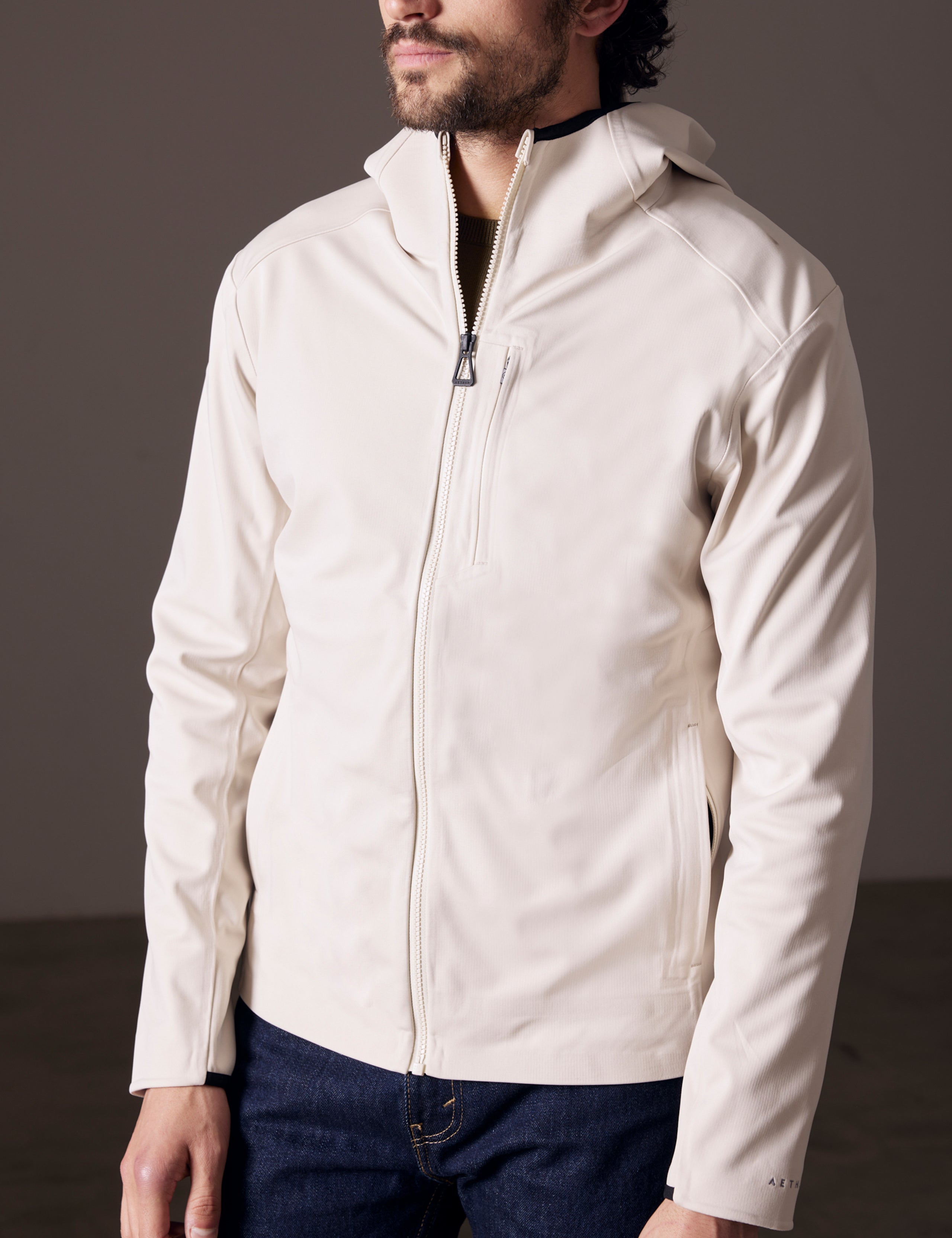 Front 3/4 body view of man wearing Hooded Tech-Fleece Full-Zip in Bone white from AETHER Apparel.