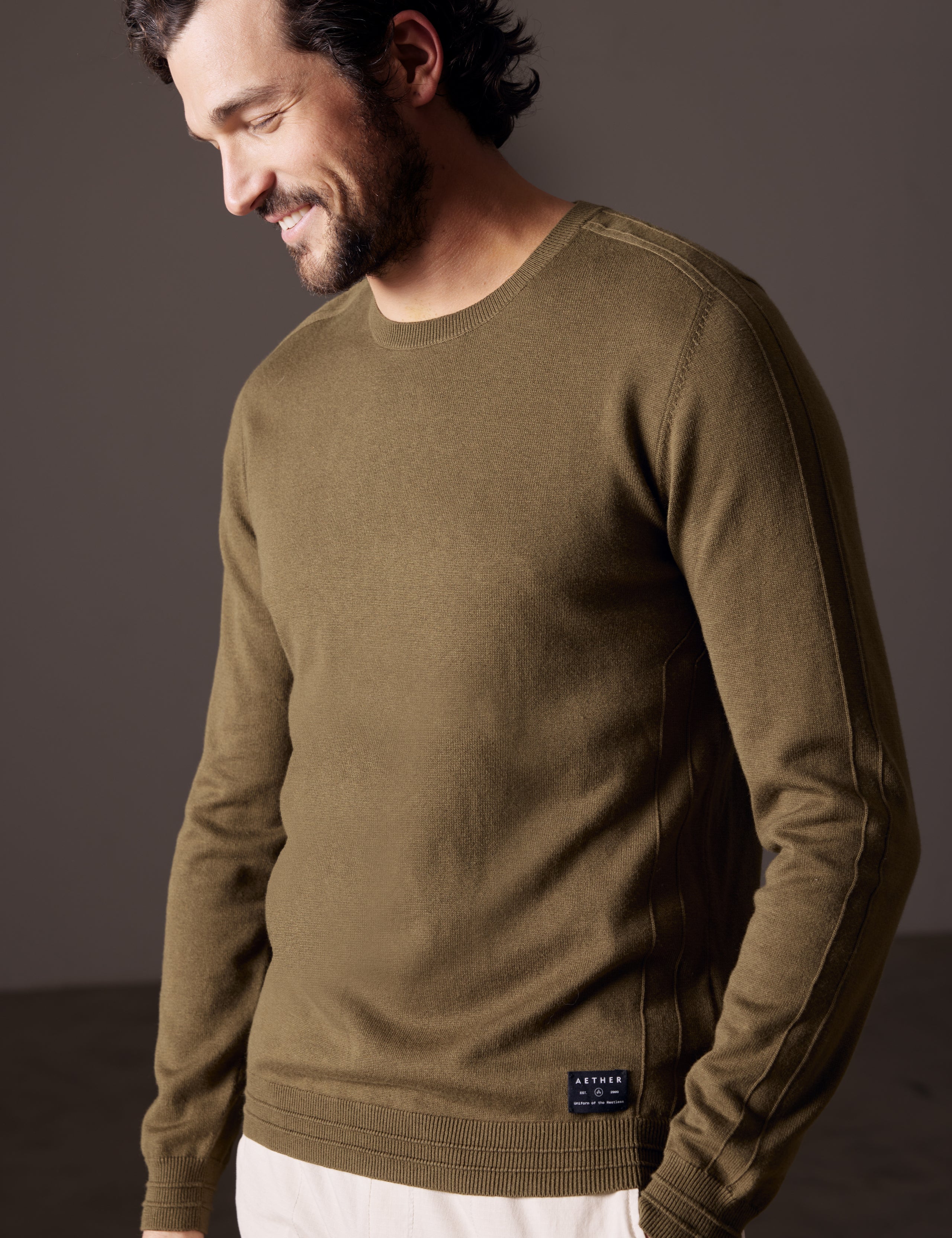 Front 3/4 body view of man wearing Irving Sweater in Command Green from AETHER Apparel.