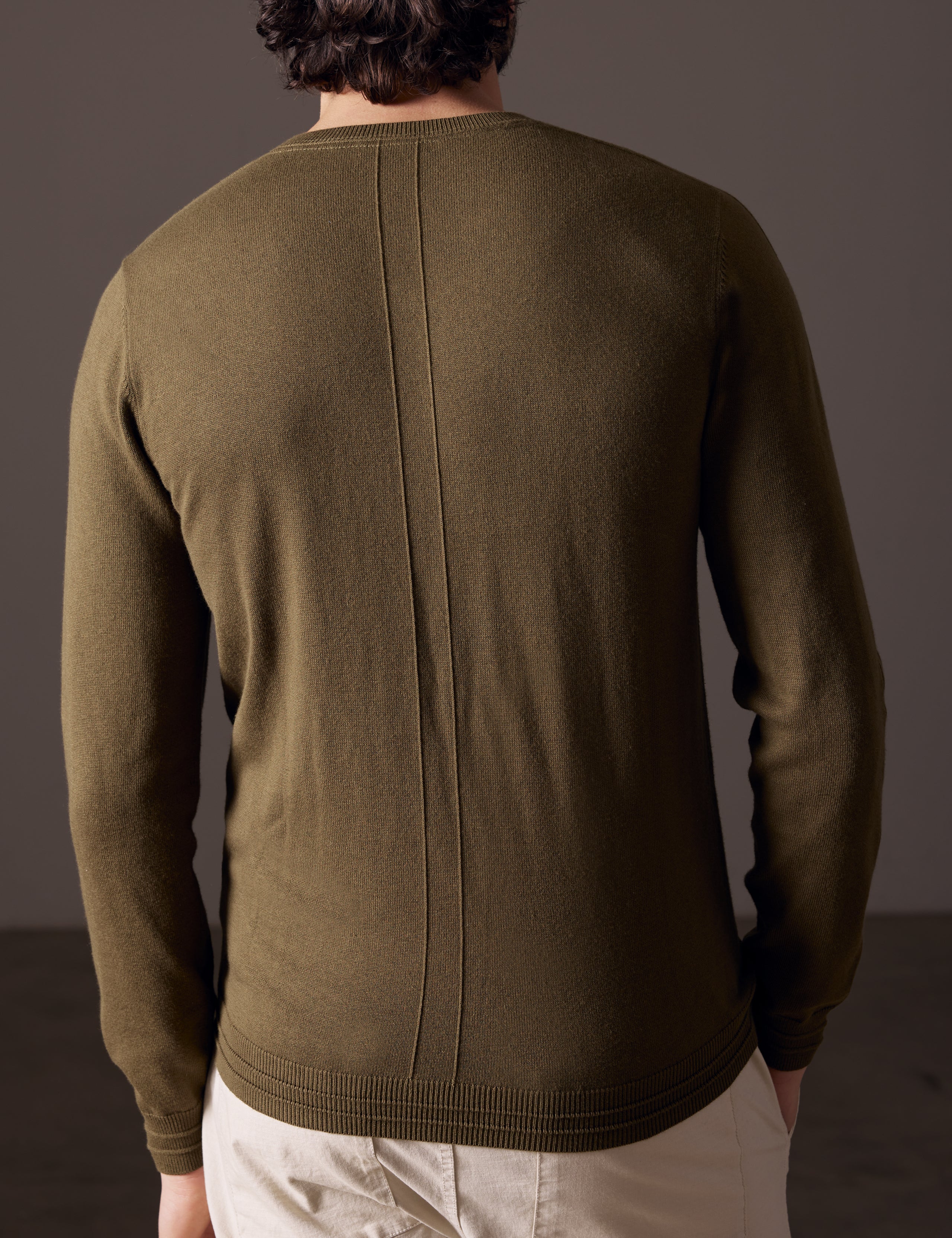 Rear body view of man wearing Irving Sweater in Command Green from AETHER Apparel.