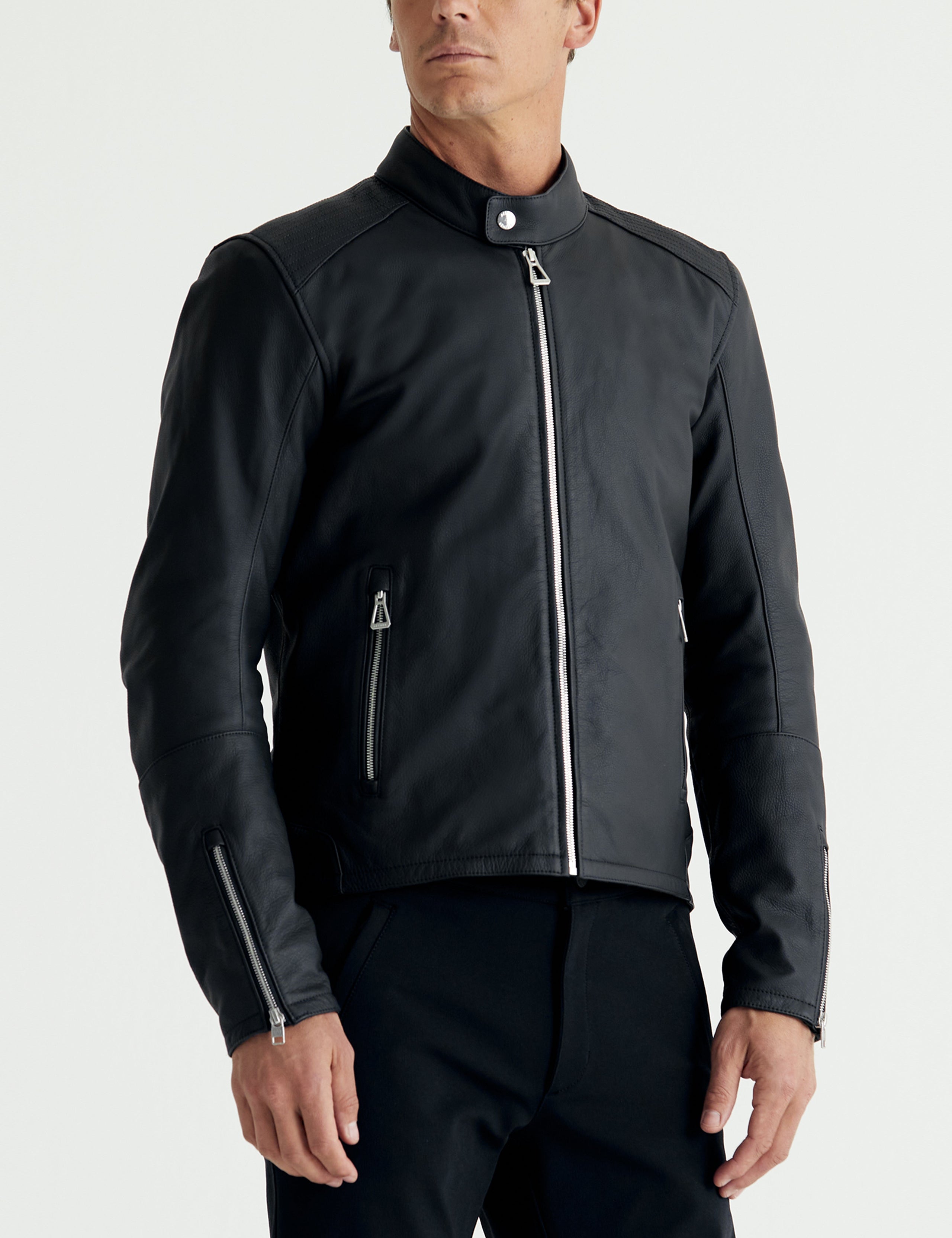Front 3/4 body view of man wearing Laslo Motorcycle Jacket in Onyx Black from AETHER Apparel.