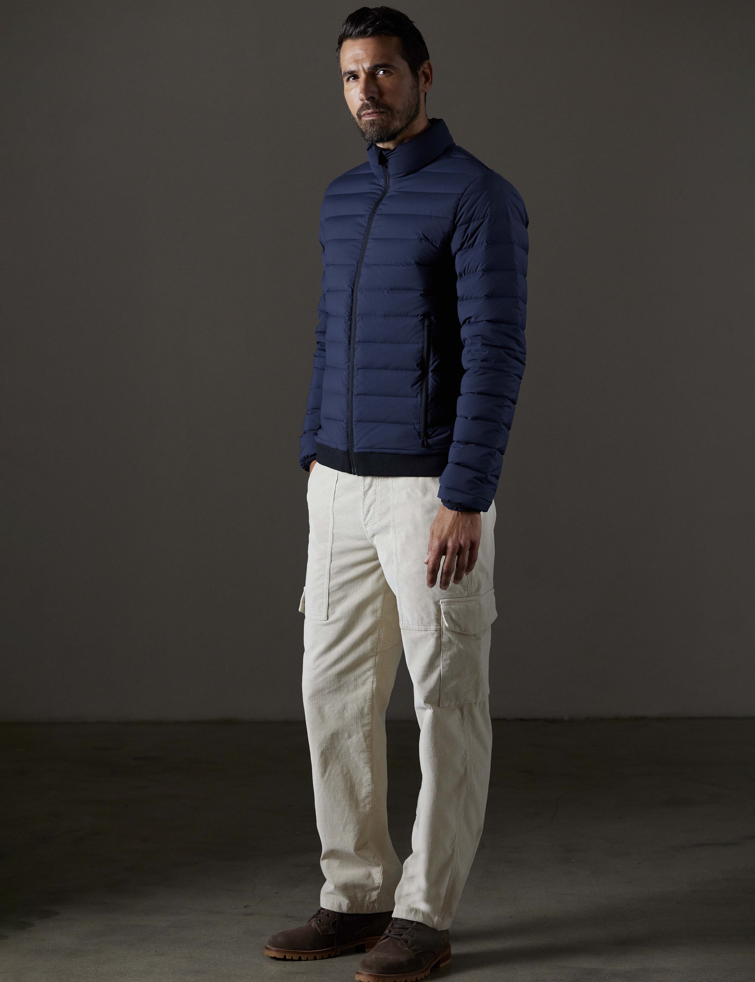 Front 3/4 full-body view of man wearing Launch Full-Zip Jacket NH in Total Eclipse dark blue from AETHER Apparel.
