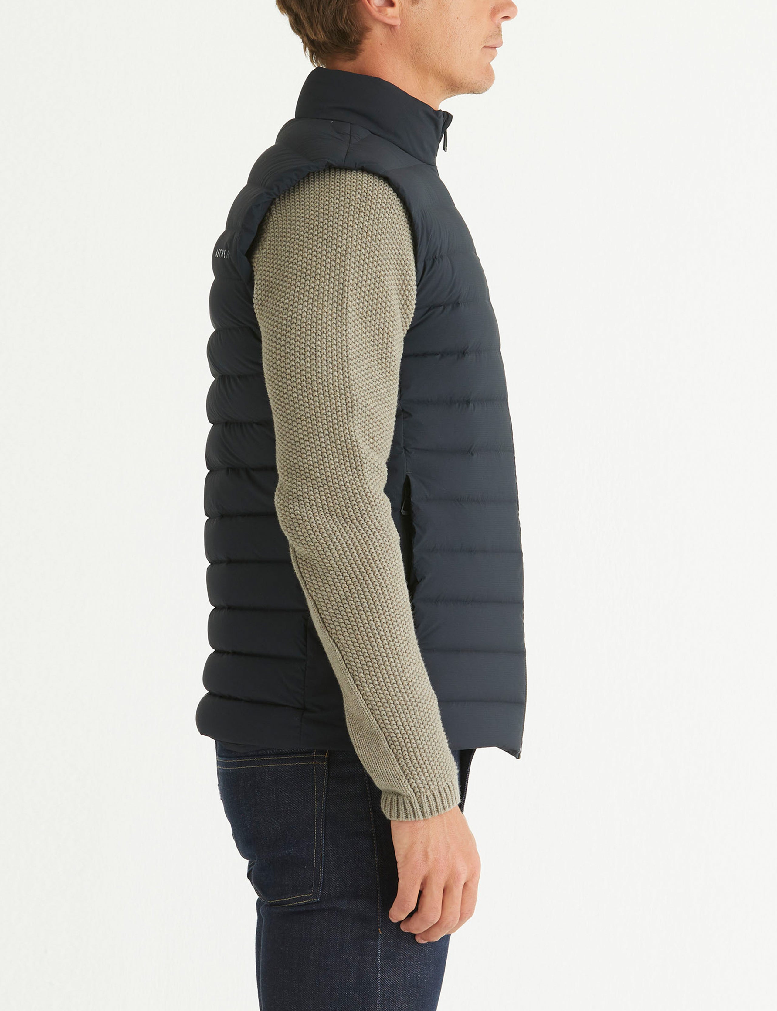 Side profile body view of man wearing Launch Vest in Onyx Black from AETHER Apparel.