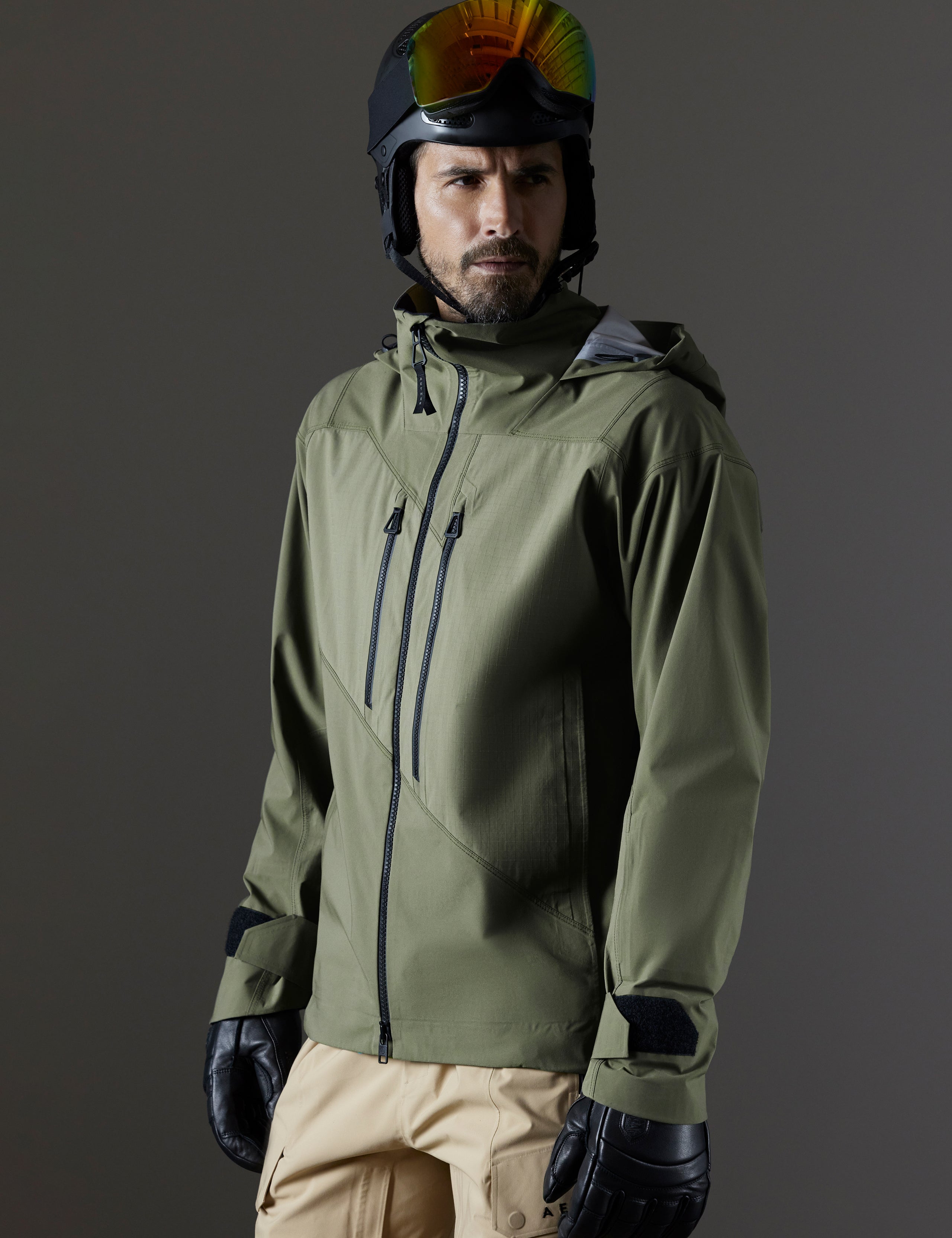 Front 3/4 body view of man wearing Maverick Snow-Shell Jacket in Fern Green from AETHER Apparel.