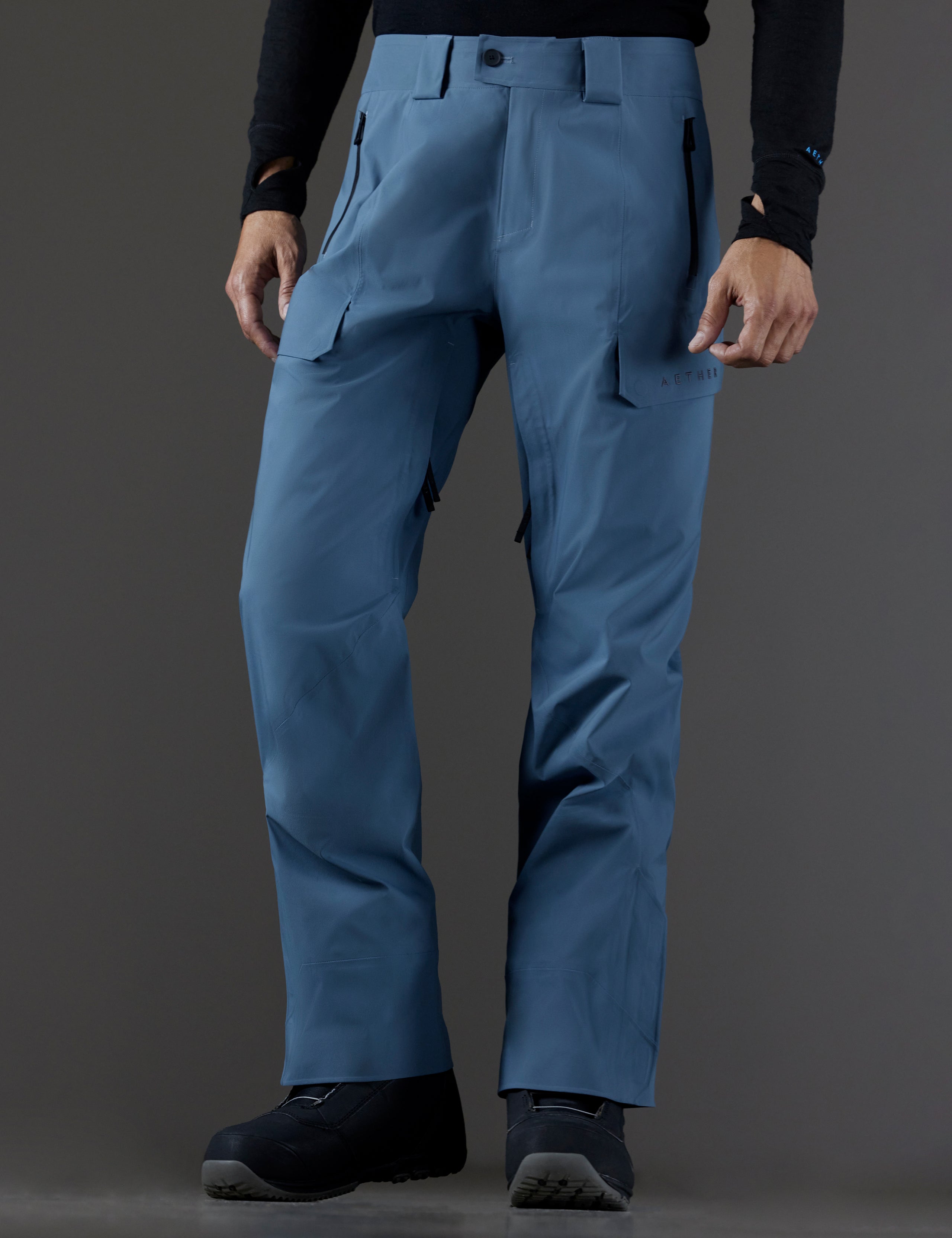 Front 3/4 lower body view of man wearing Maverick Snow-Shell Pant in Portal Blue from AETHER Apparel.