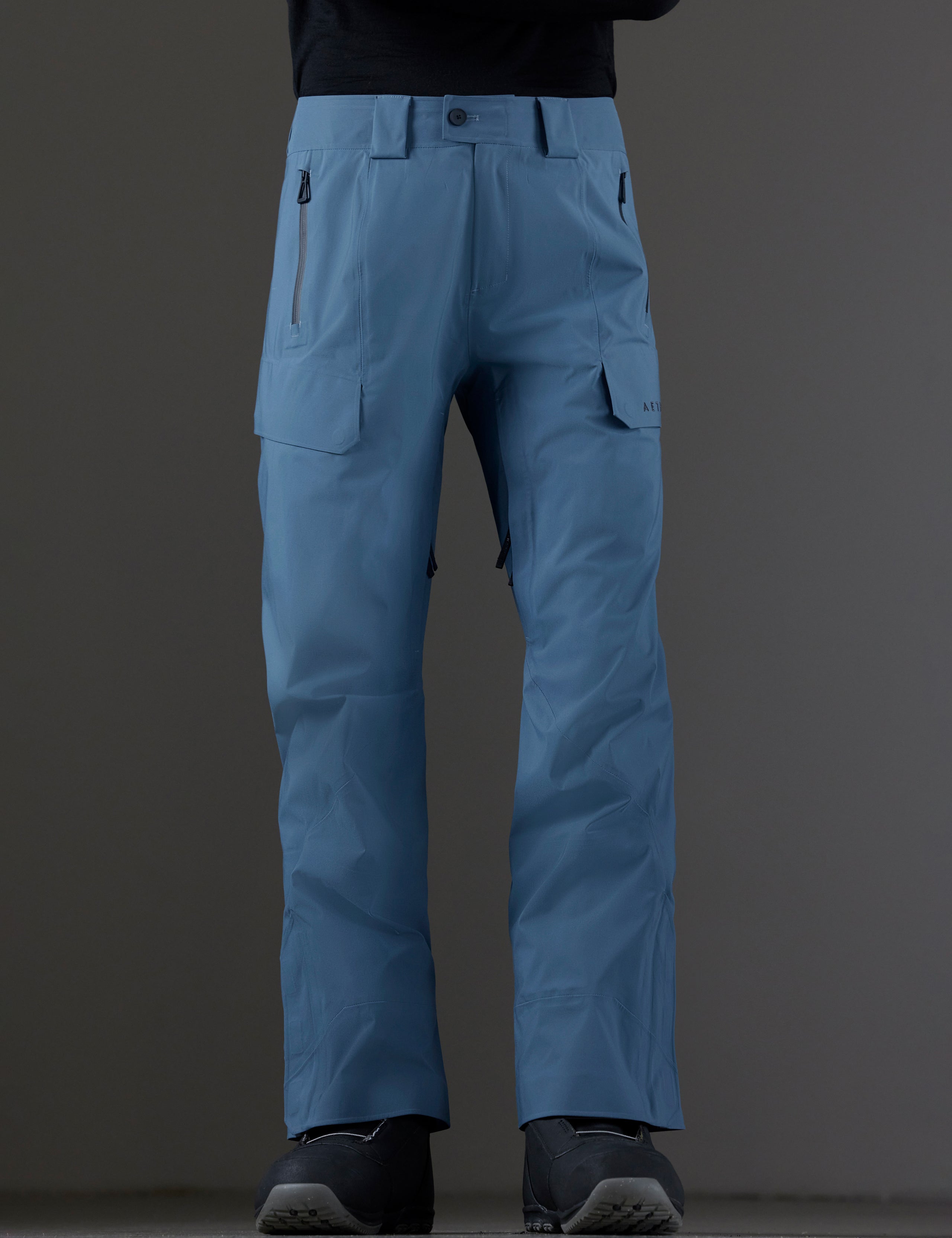 Front lower body view of man wearing Maverick Snow-Shell Pant in Portal Blue from AETHER Apparel.