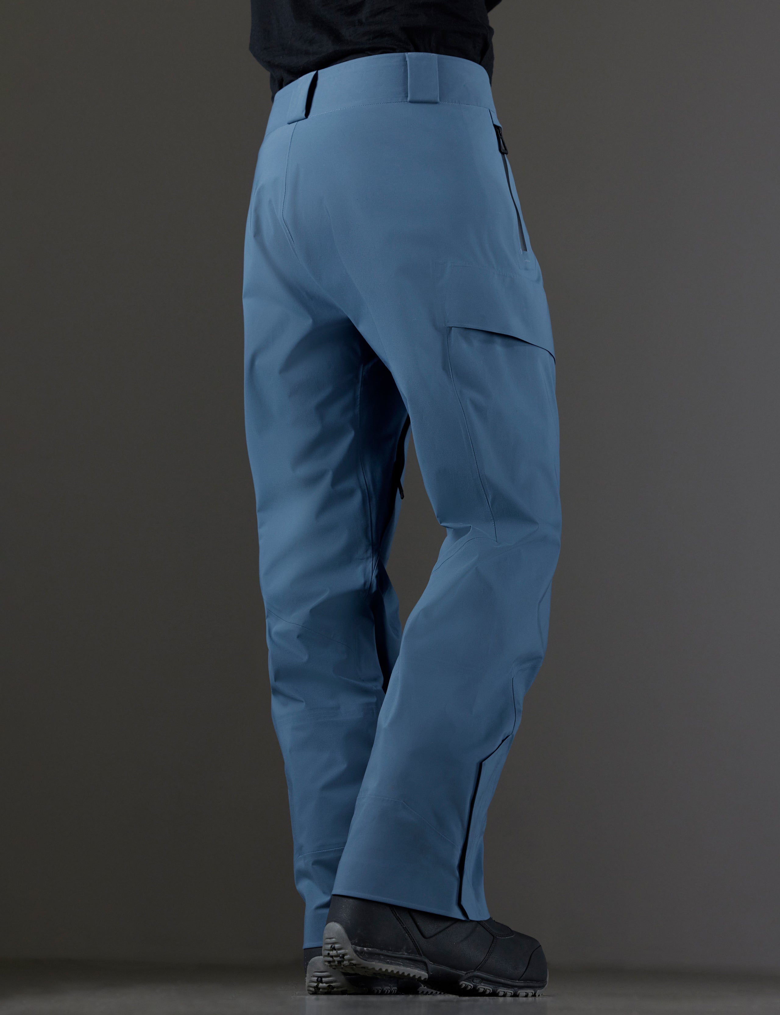 Rear 3/4 lower body view of man wearing Maverick Snow-Shell Pant in Portal Blue from AETHER Apparel.