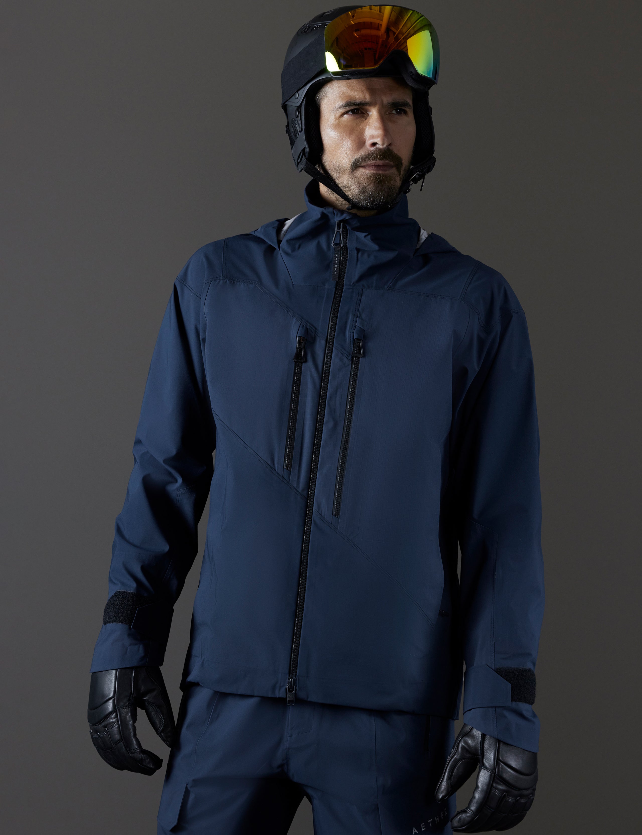 Front body view of man wearing Maverick Snow-Shell Jacket in Total Eclipse dark blue from AETHER Apparel.