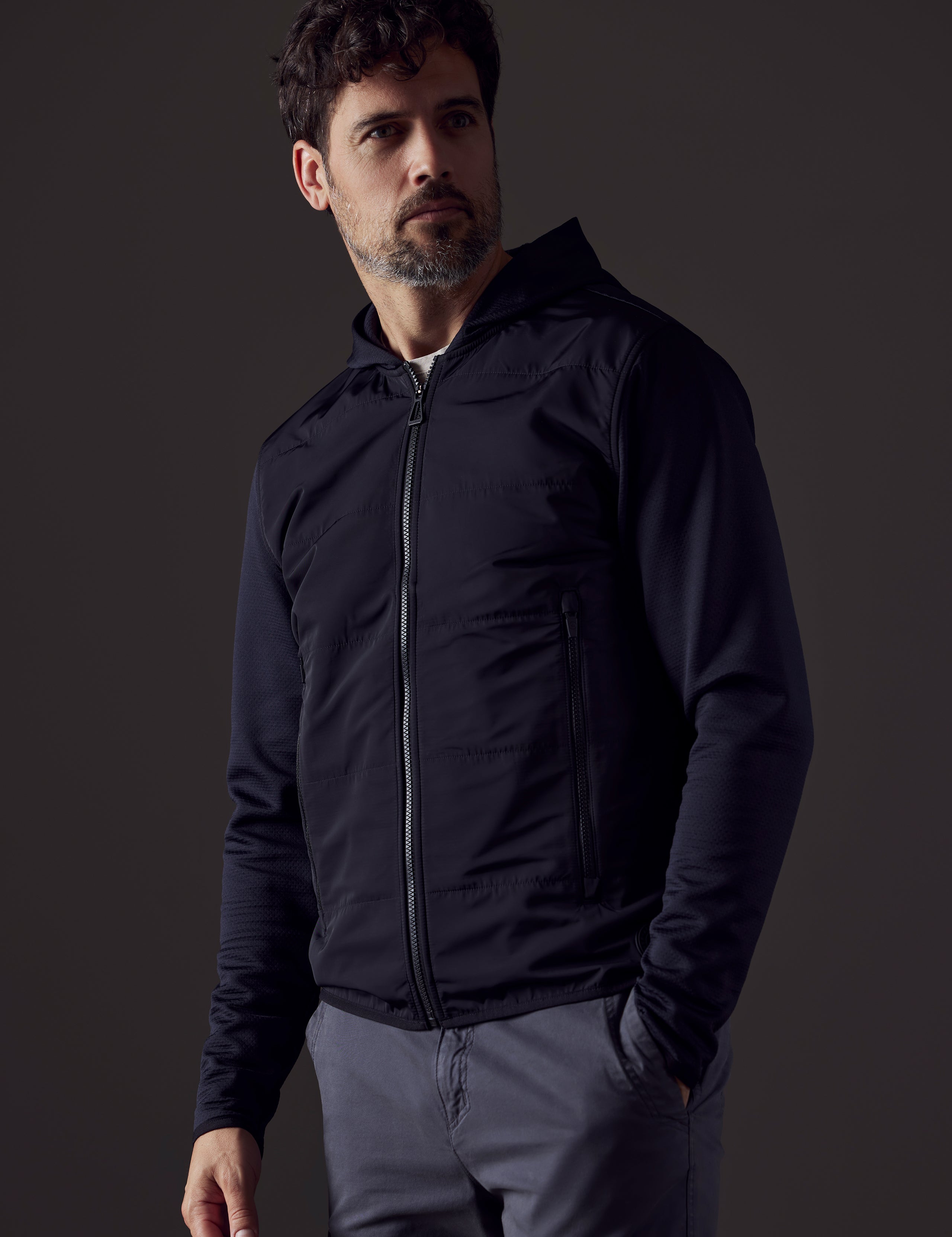 Front 3/4 body view of man wearing Morgan Technical Hoodie in Onyx Black from AETHER Apparel.