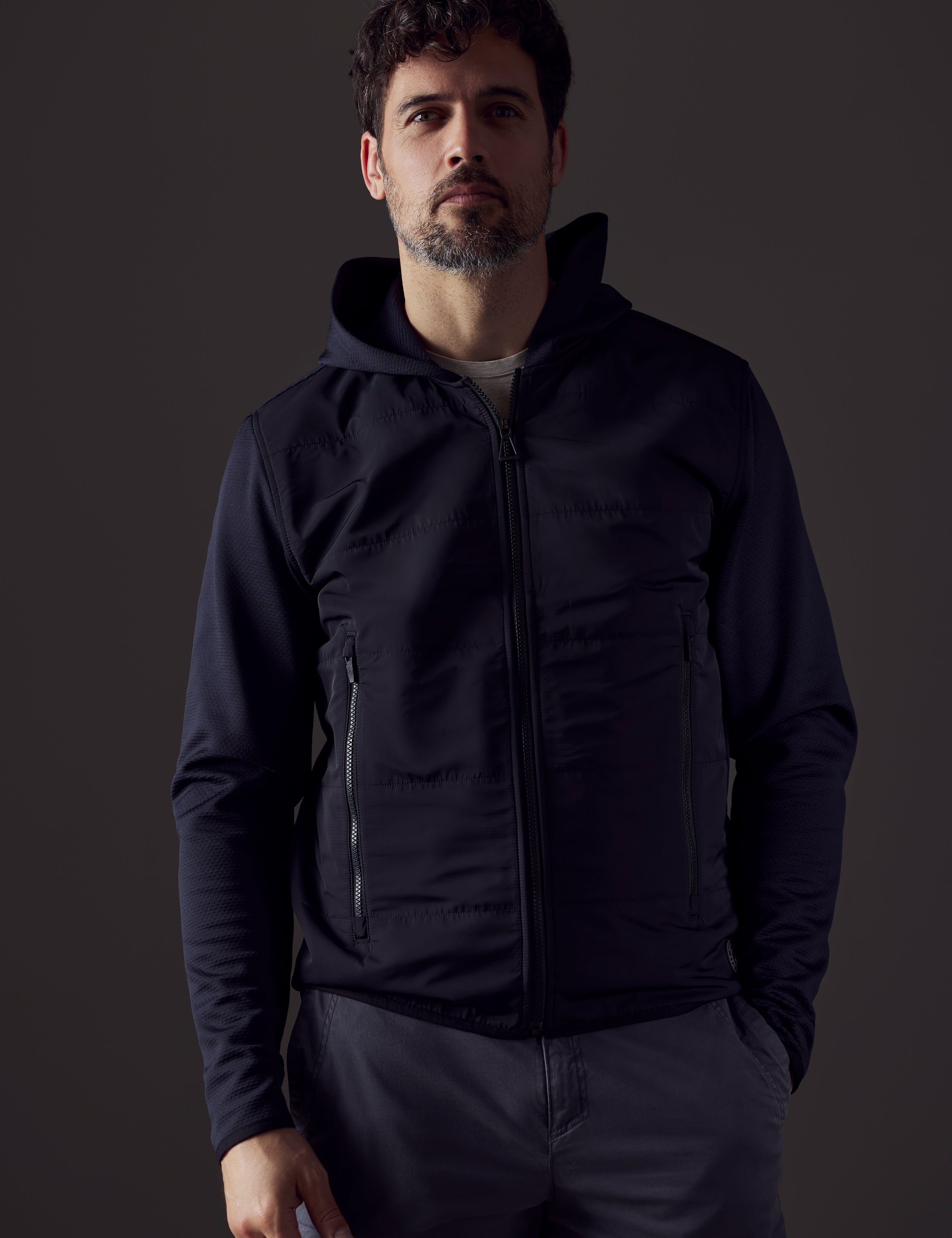 Front body view of man wearing Morgan Technical Hoodie in Onyx Black from AETHER Apparel.