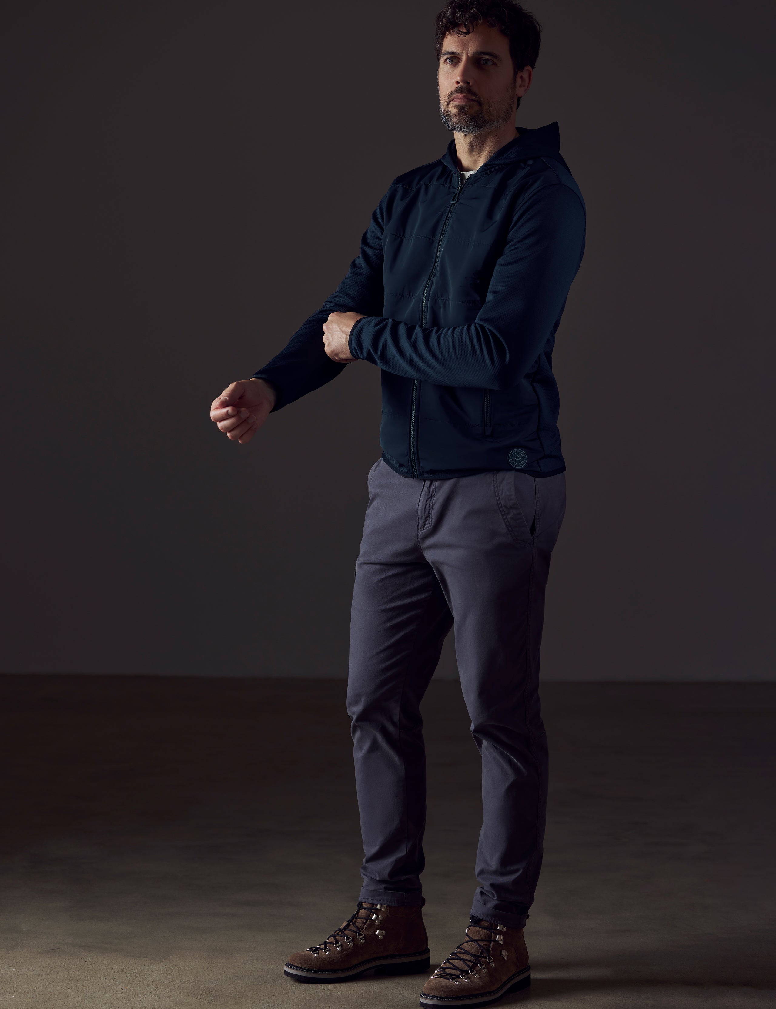 Front 3/4 full-body view of man wearing Morgan Technical Hoodie in Total Eclipse dark blue from AETHER Apparel.