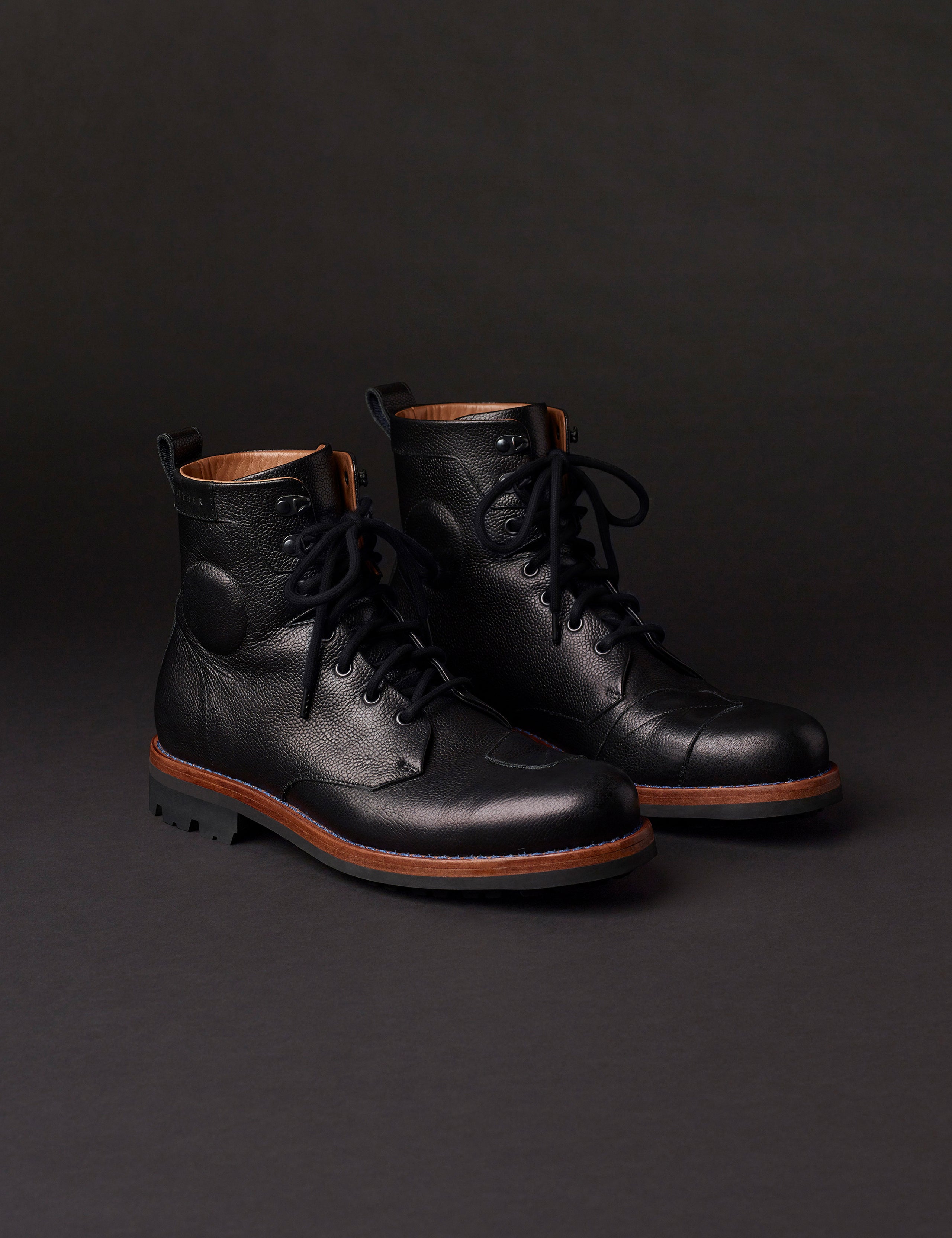 Front angled view of AETHER Moto Boot in Jet Black with black laces from AETHER Apparel.