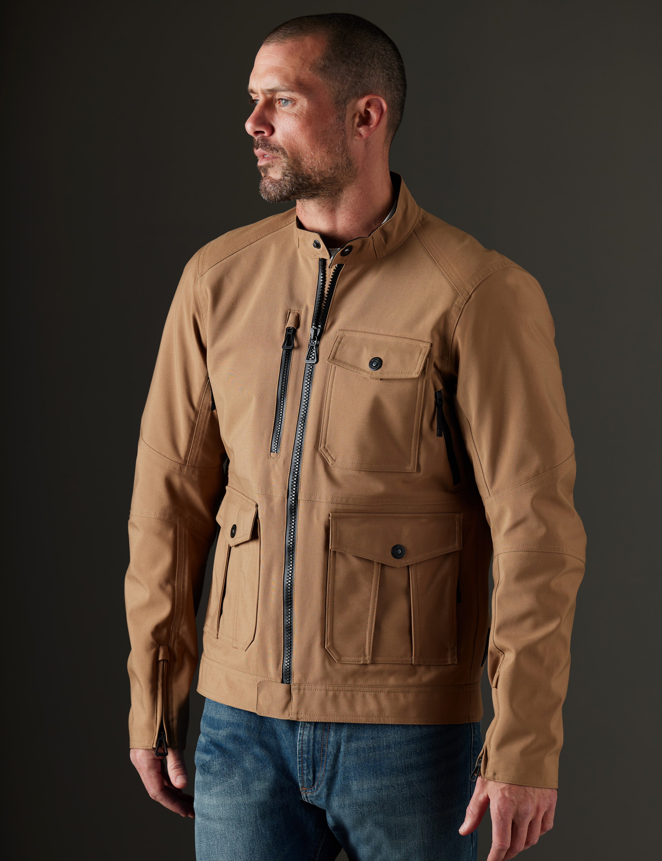 Front 3/4 body view of man wearing Mulholland Motorcycle Jacket in Reverse Brown from AETHER Apparel.