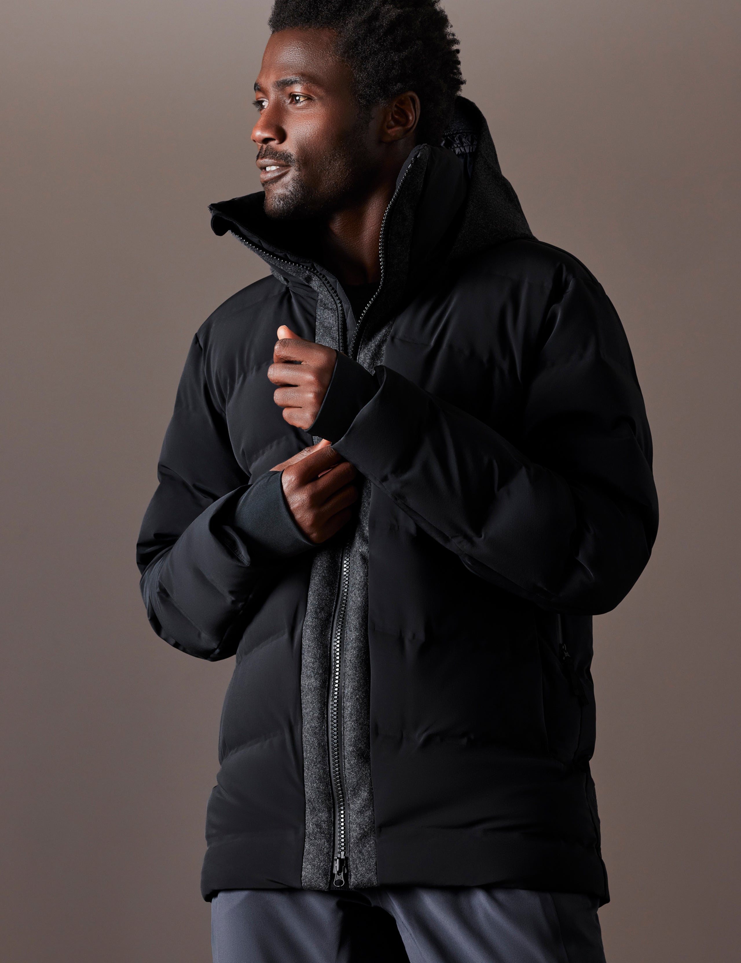 Front 3/4 body view of man wearing Nordic Jacket in Jet Black from AETHER Apparel.