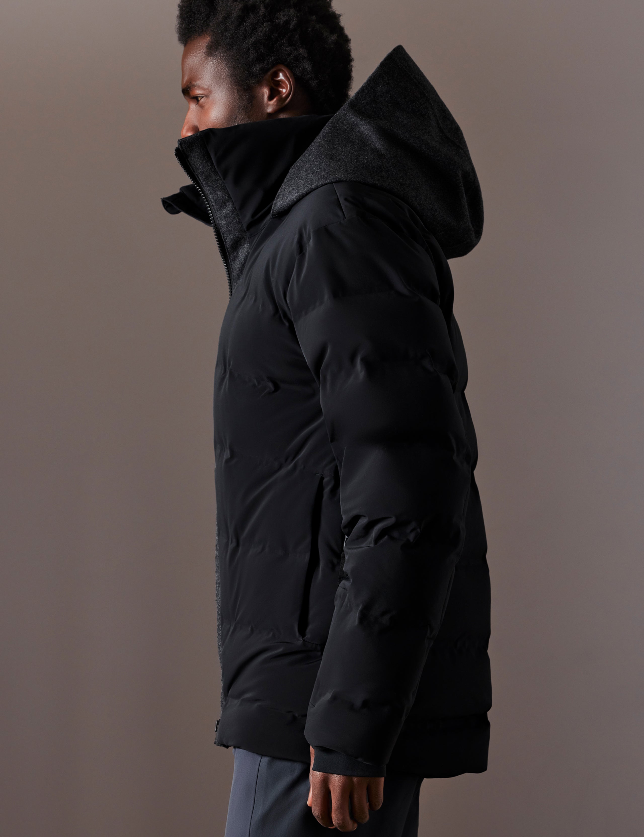Left side profile body view of man wearing Nordic Jacket in Jet Black from AETHER Apparel.