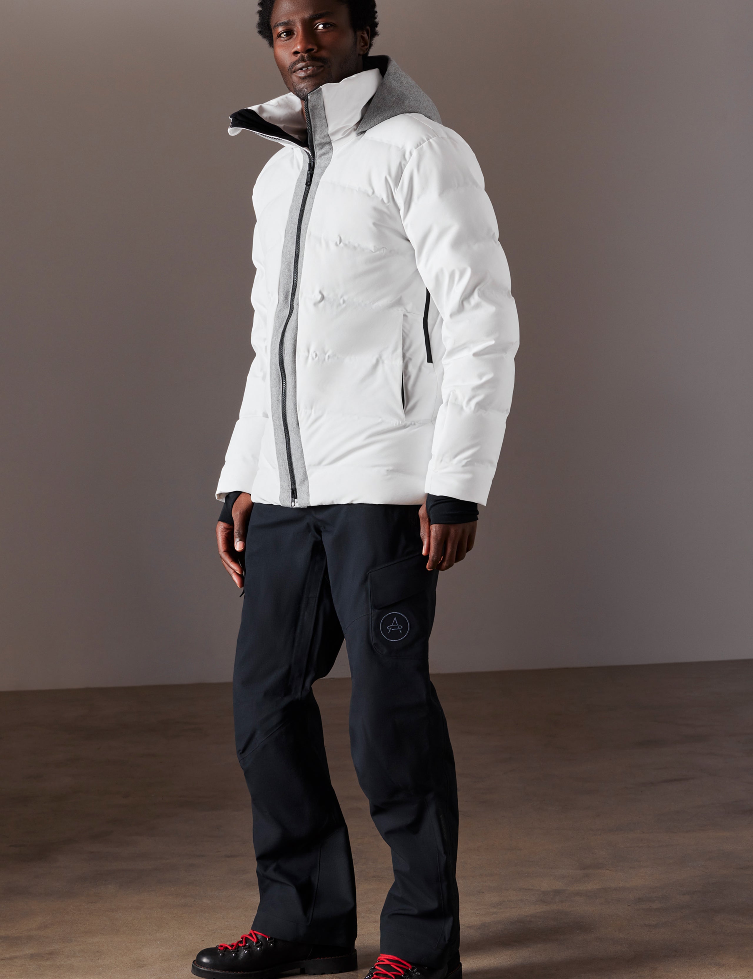 Front 3/4 full-body view of man wearing Nordic Jacket in White from AETHER Apparel.