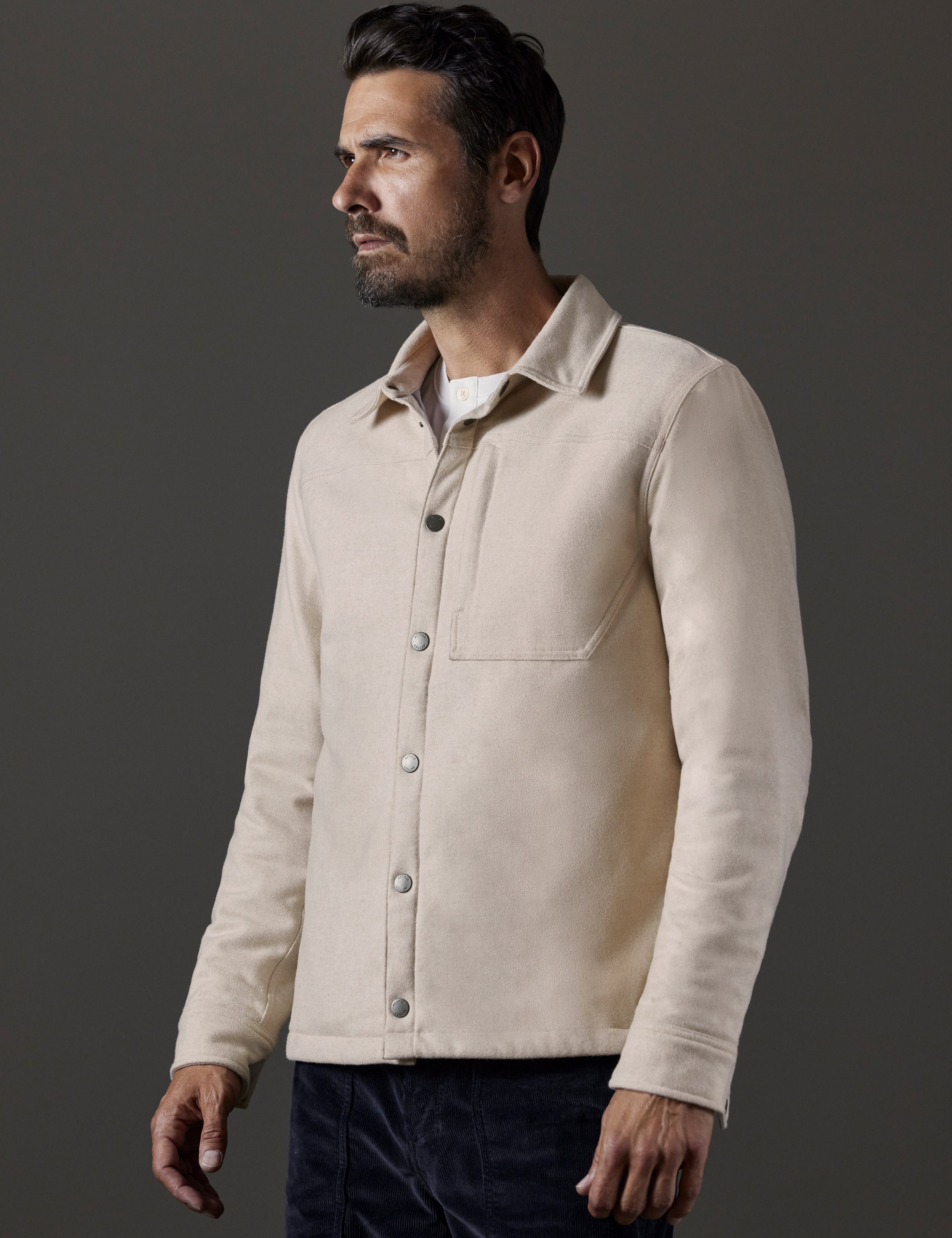 Front 3/4 body view of man wearing Nova Insulated Button-Down in Bone Heather white from AETHER Apparel.