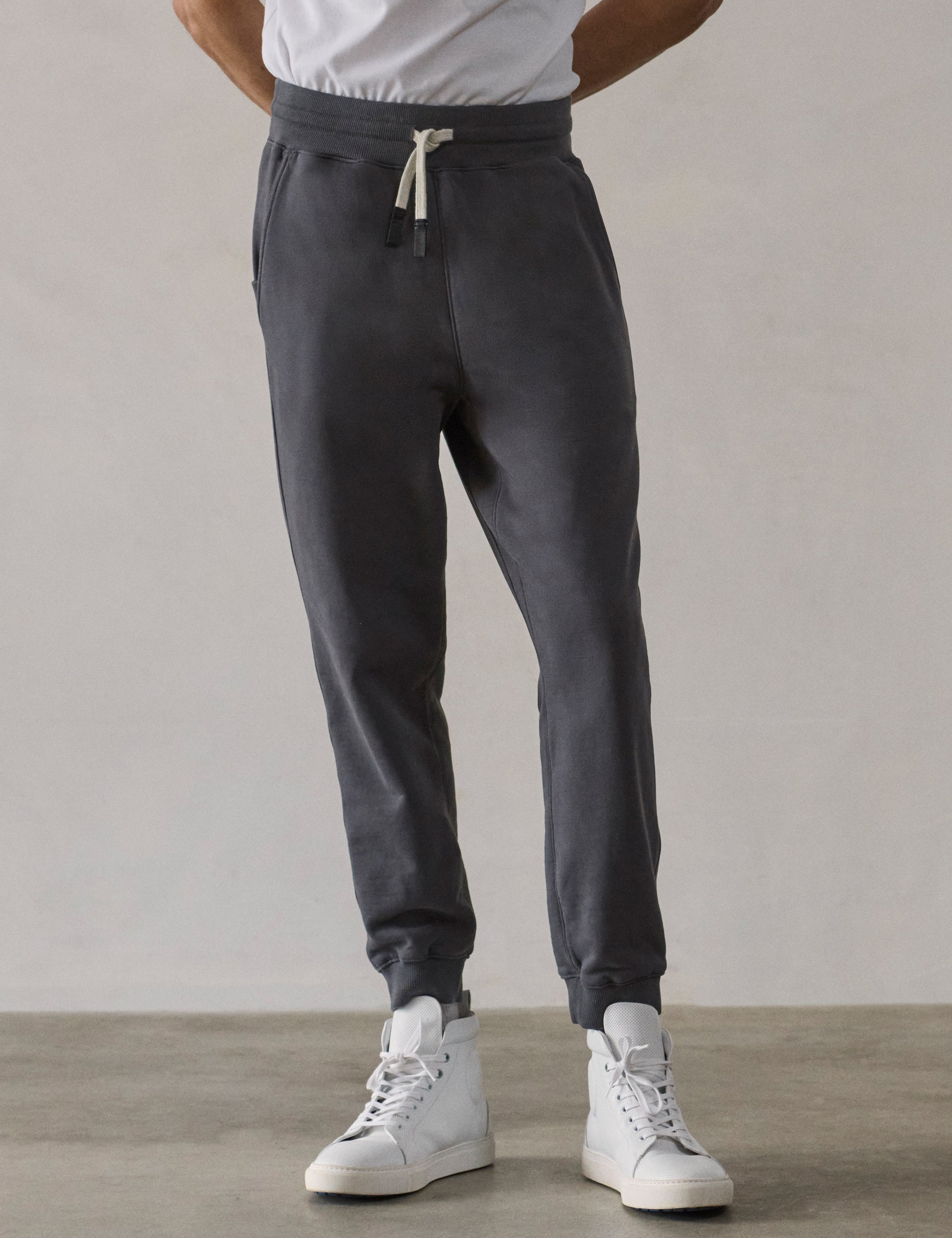 Front lower-body view of man wearing Osa Cuffed Sweatpant in Graphite grey from AETHER Apparel.