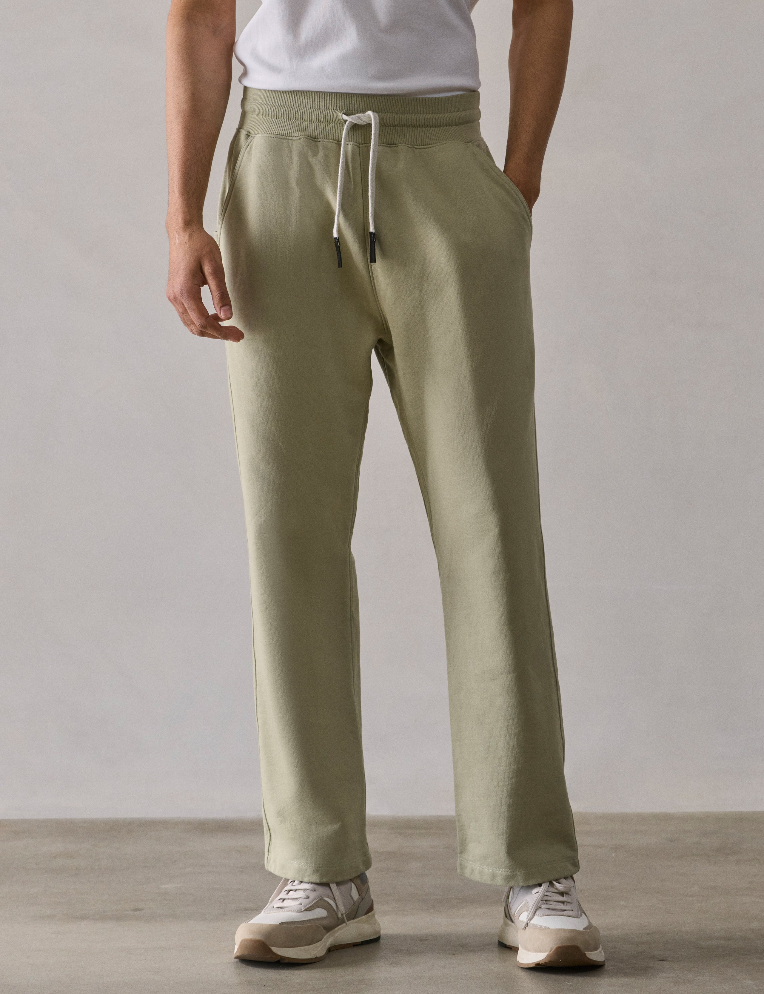 Front lower body view of man wearing Osa Easy-Fit Sweatpant in Sage Green from AETHER Apparel.