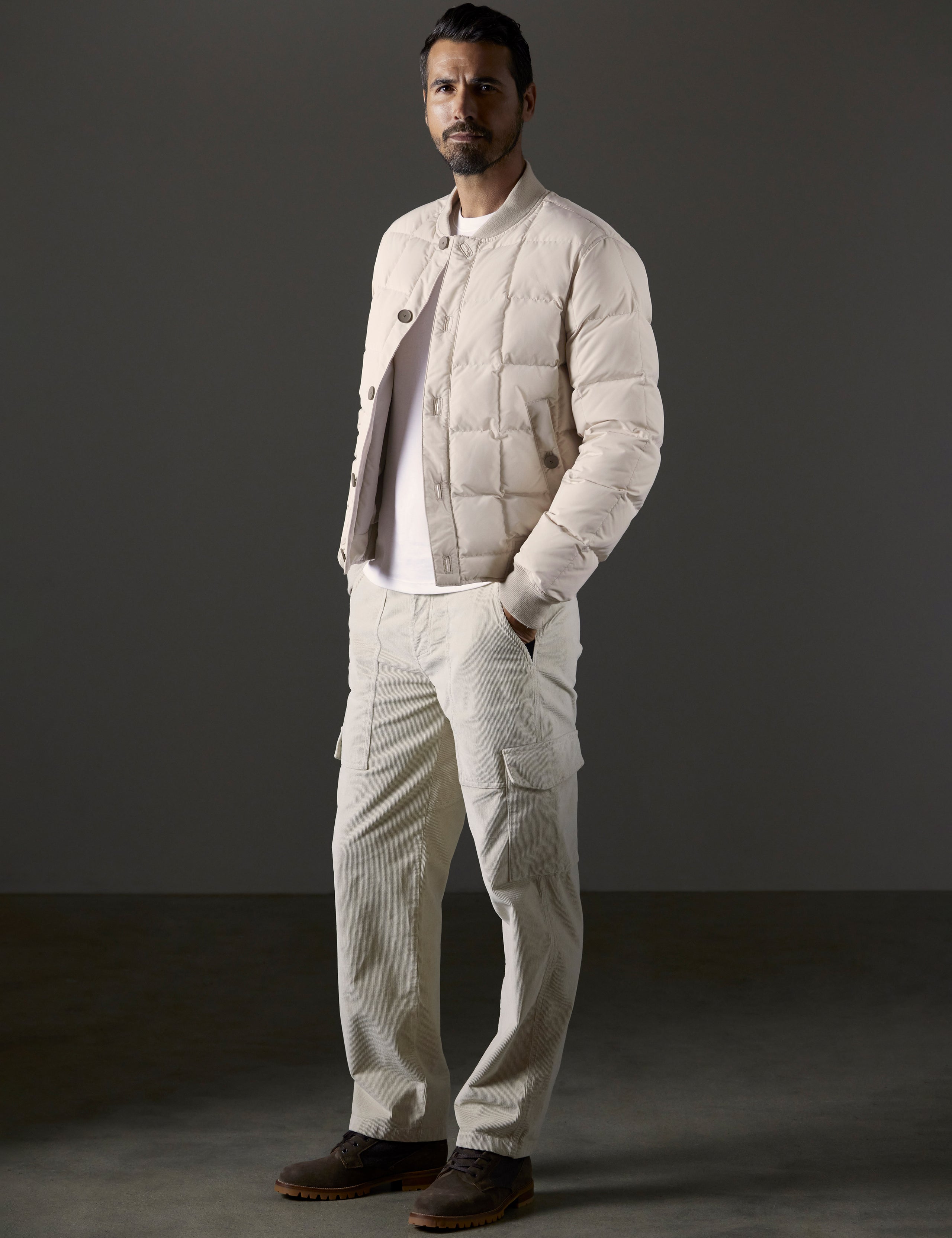 Front full body view of man wearing Pacer Jacket in Bone white from AETHER Apparel.
