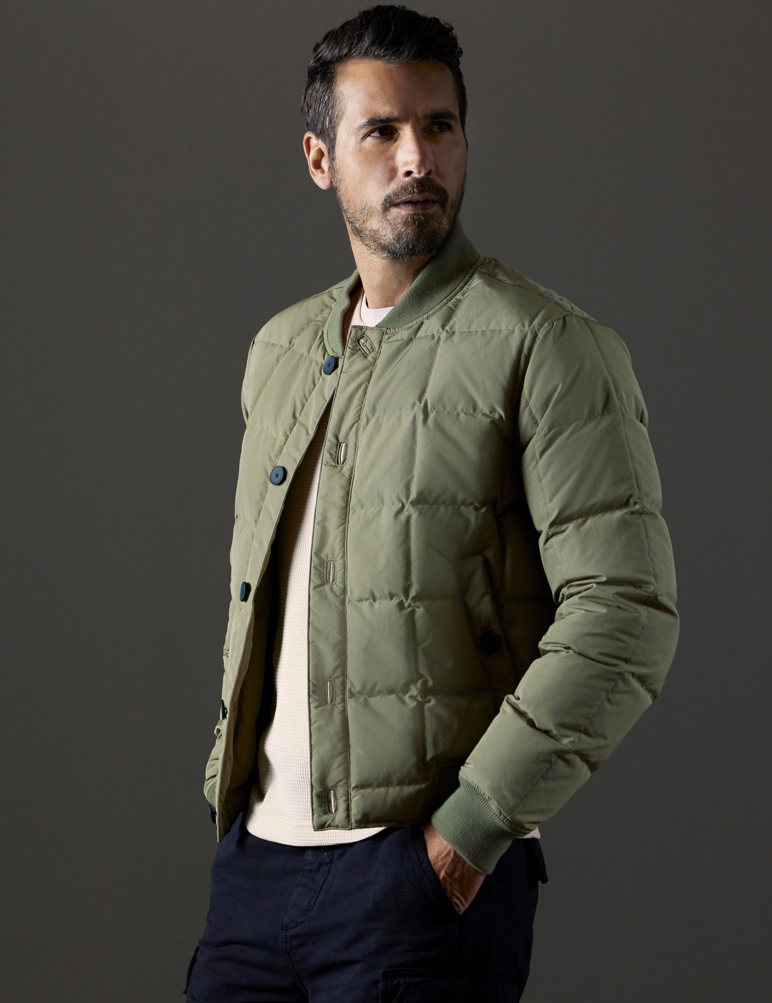 Front 3/4 body view of man wearing Pacer Jacket in Fern Green from AETHER Apparel.