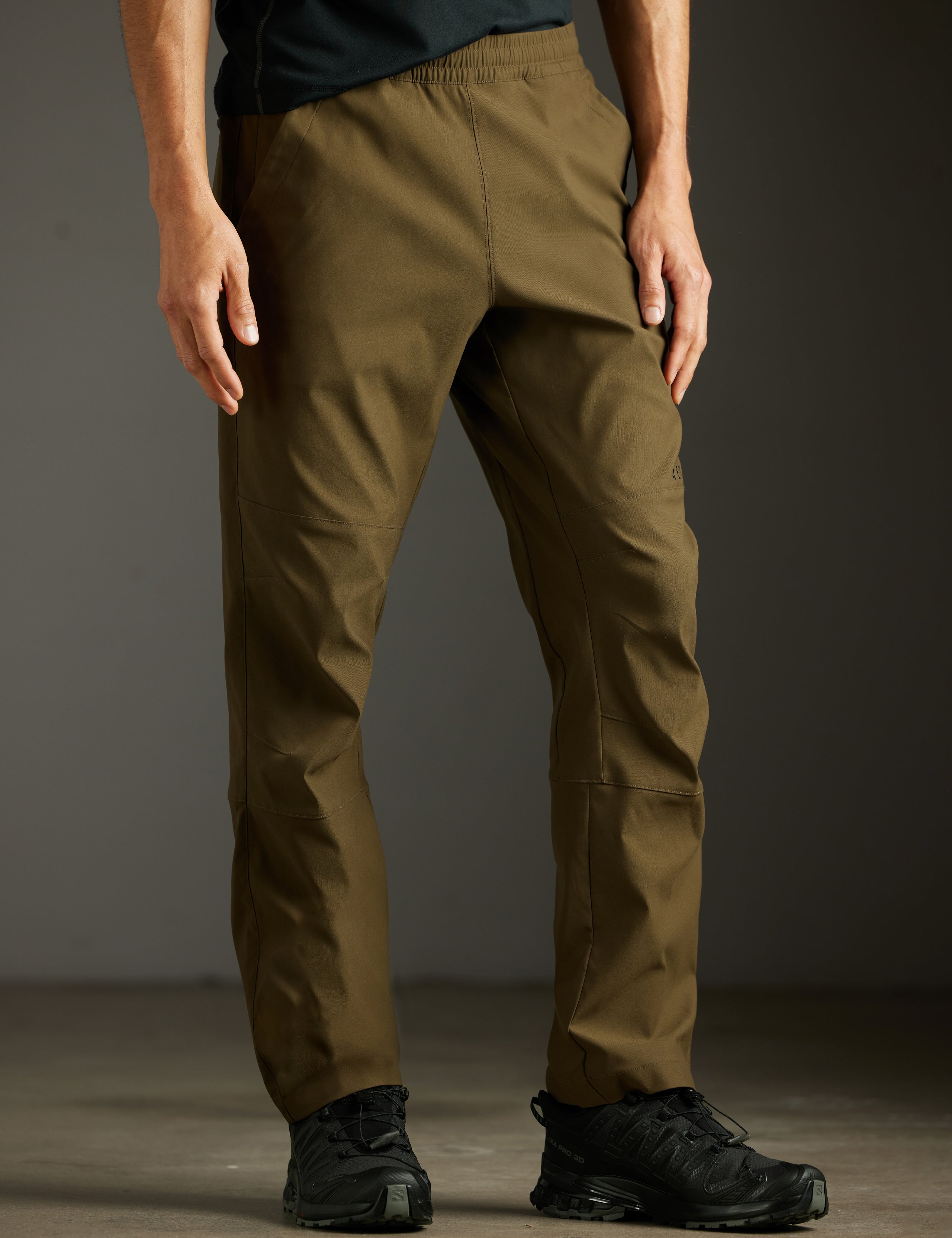 Front 3/4 lower body view of man wearing Perth Pant in Cadet Green from AETHER Apparel.