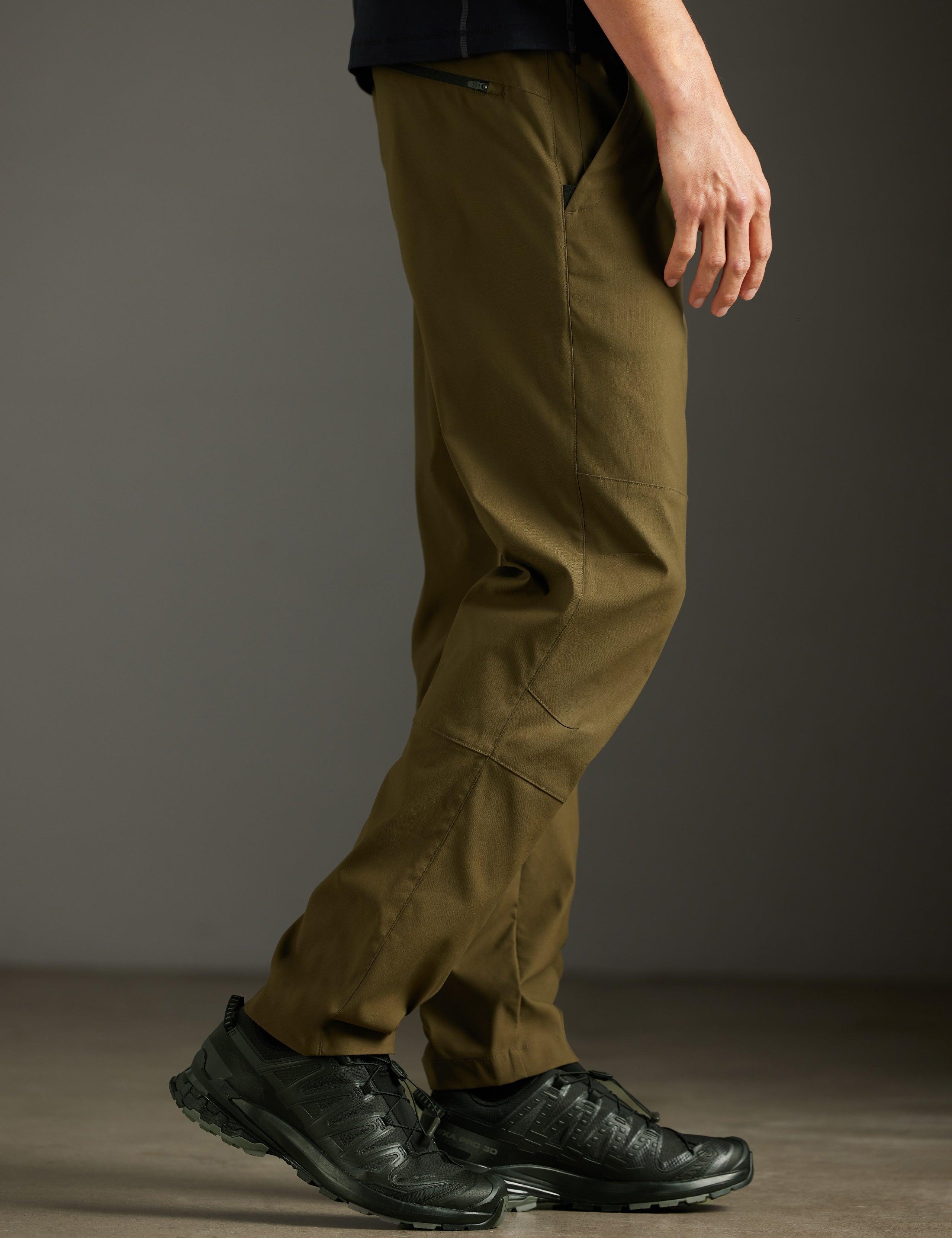 Side profile lower body view of man wearing Perth Pant in Cadet Green from AETHER Apparel.