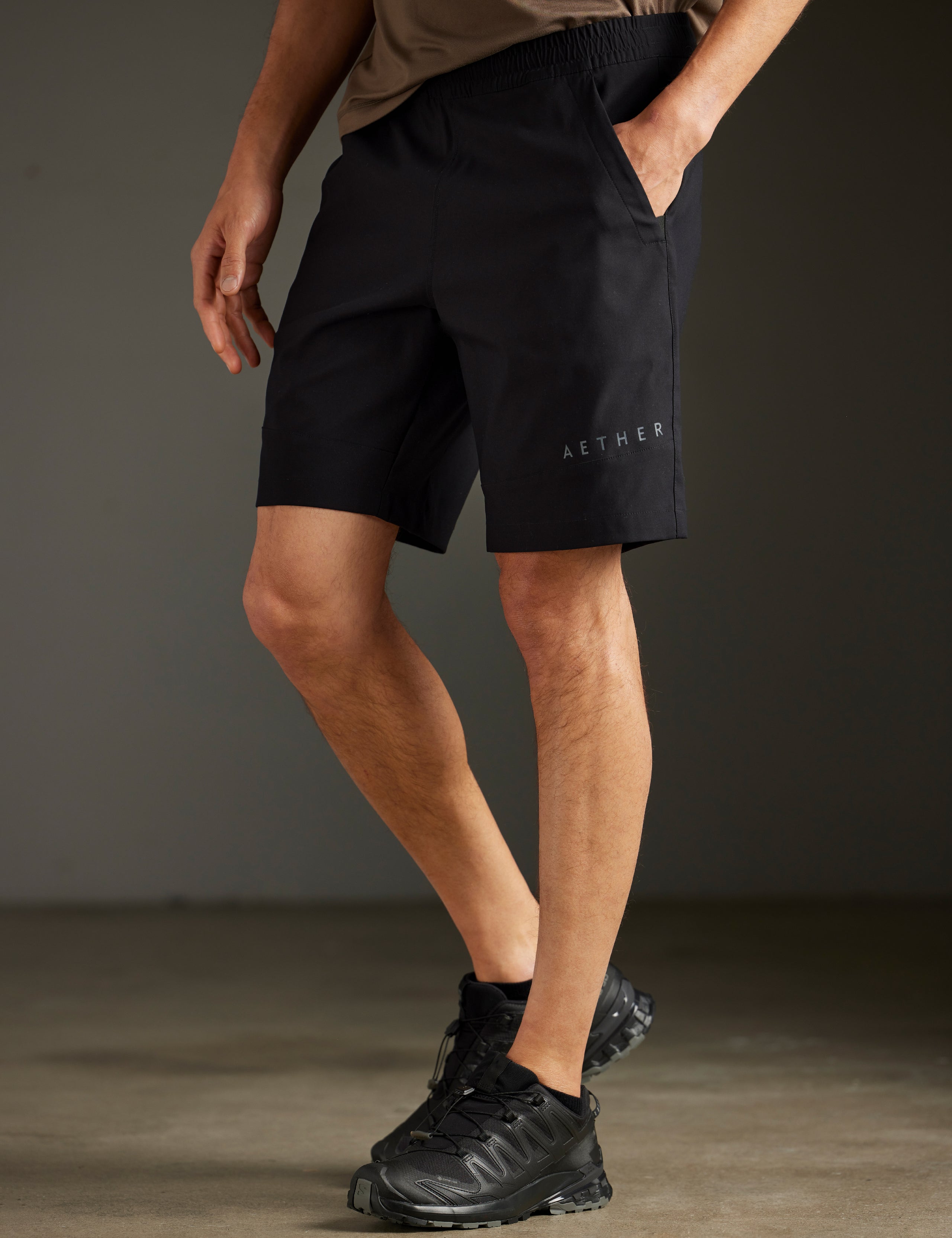 Front 3/4 lower body view of man wearing Perth Short in Onyx Black from AETHER Apparel.