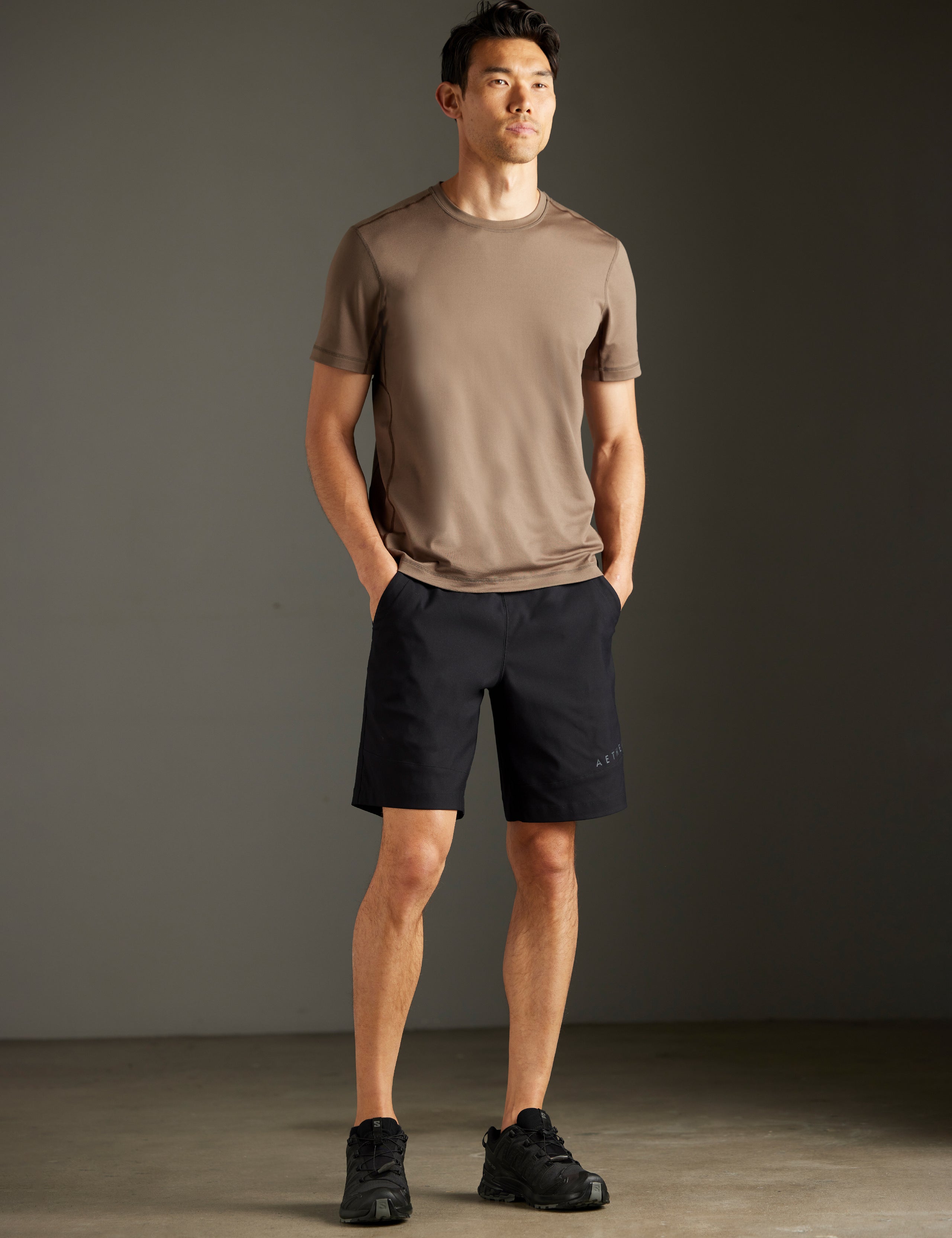 Front 3/4 full-body view of man wearing Perth Short in Onyx Black from AETHER Apparel.