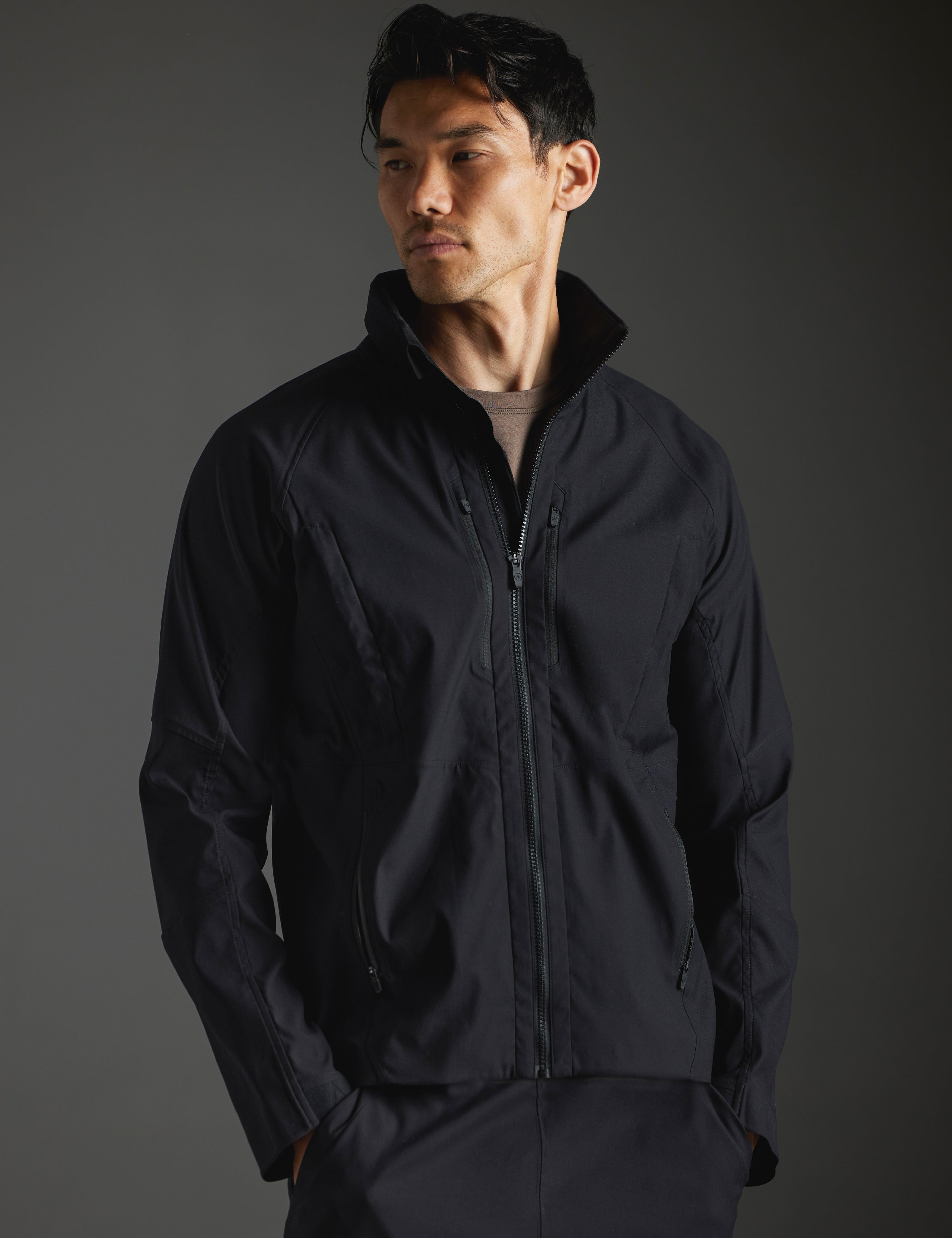 Front body view of man wearing Perth Vented Jacket in Onyx Black from AETHER Apparel.