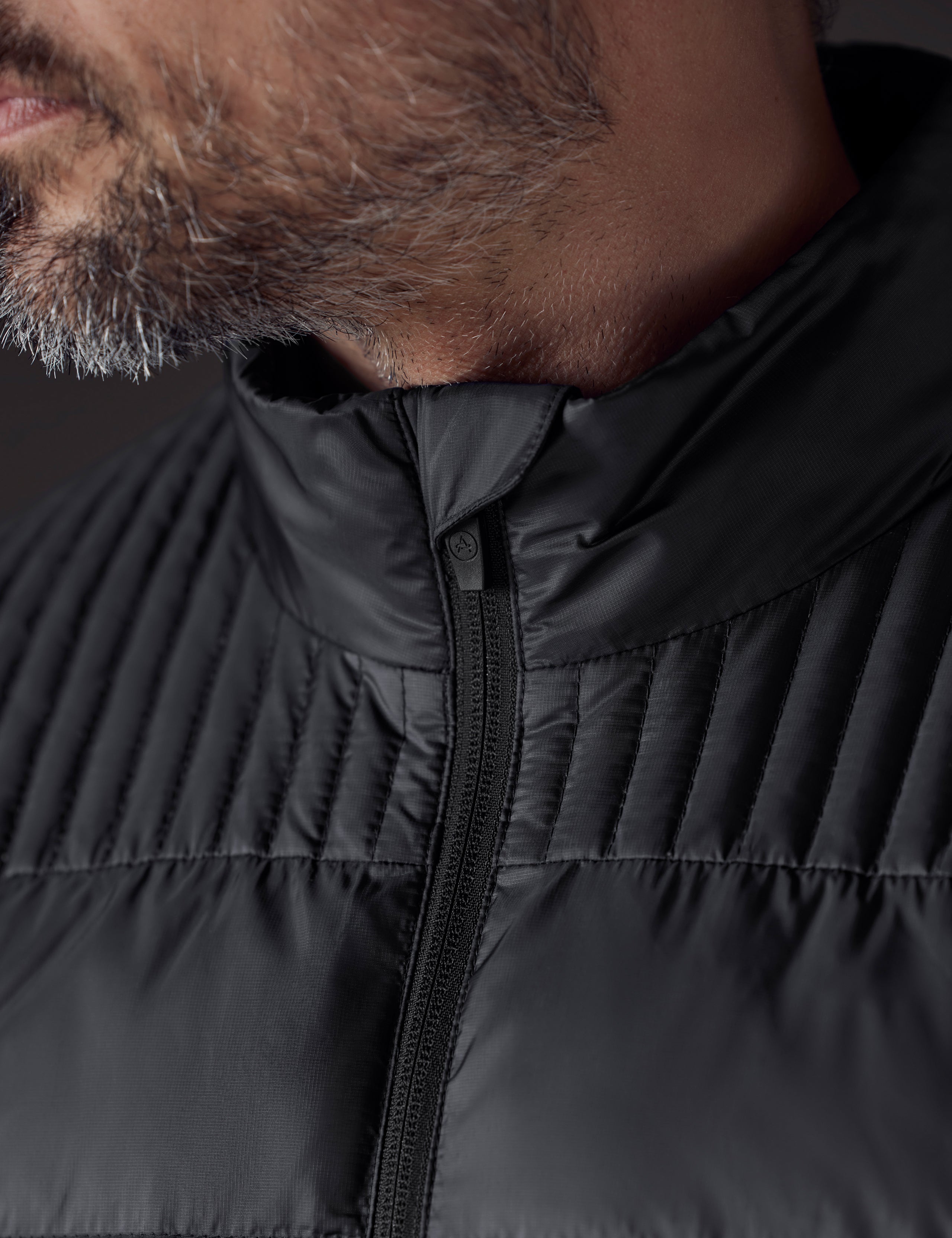 Closeup detailed view of main zipper, collar, and stitching on Phantom Jacket in Onyx Black from AETHER Apparel.