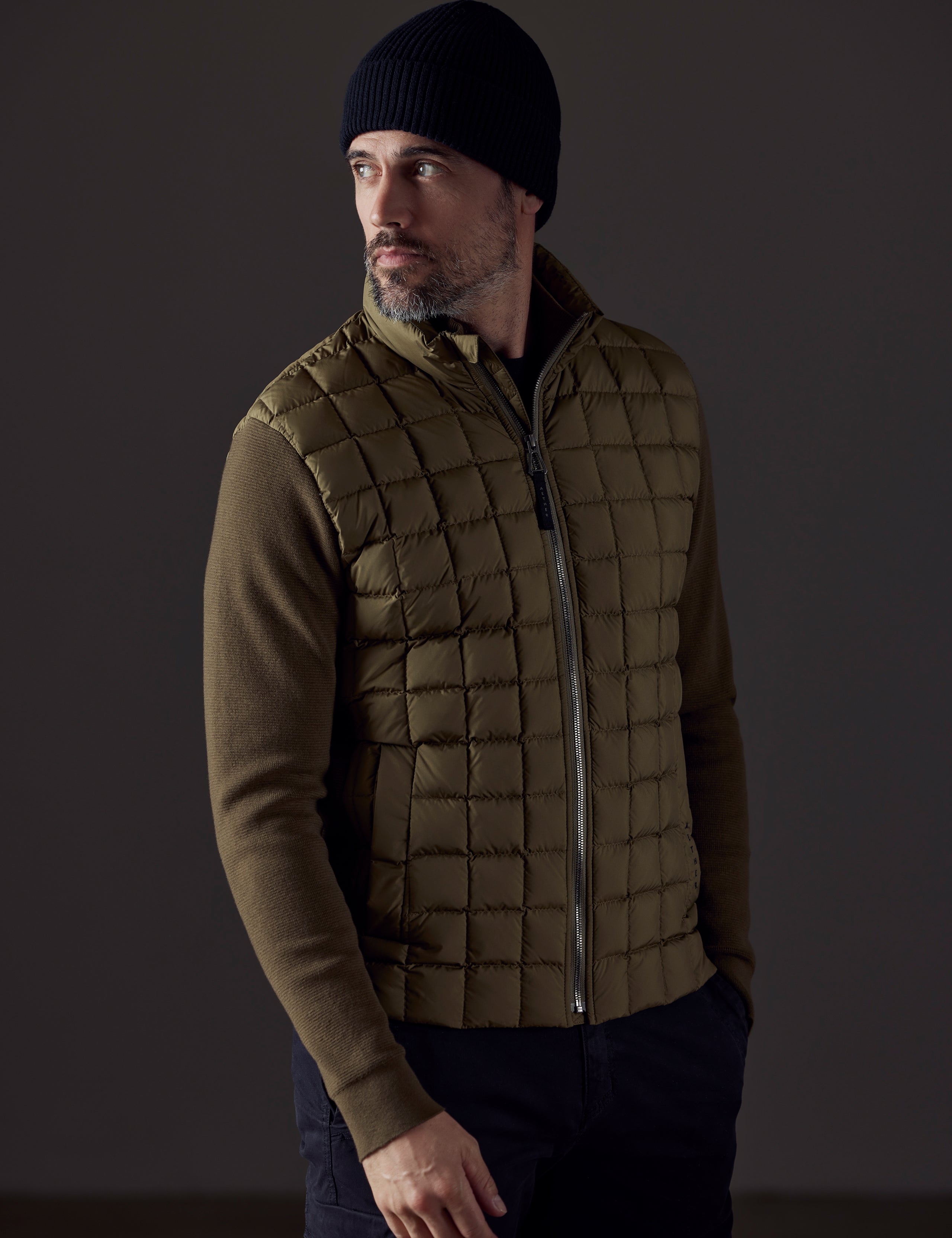 Front 3/4 body view of man wearing Phase Full-Zip in Command Green from AETHER Apparel.